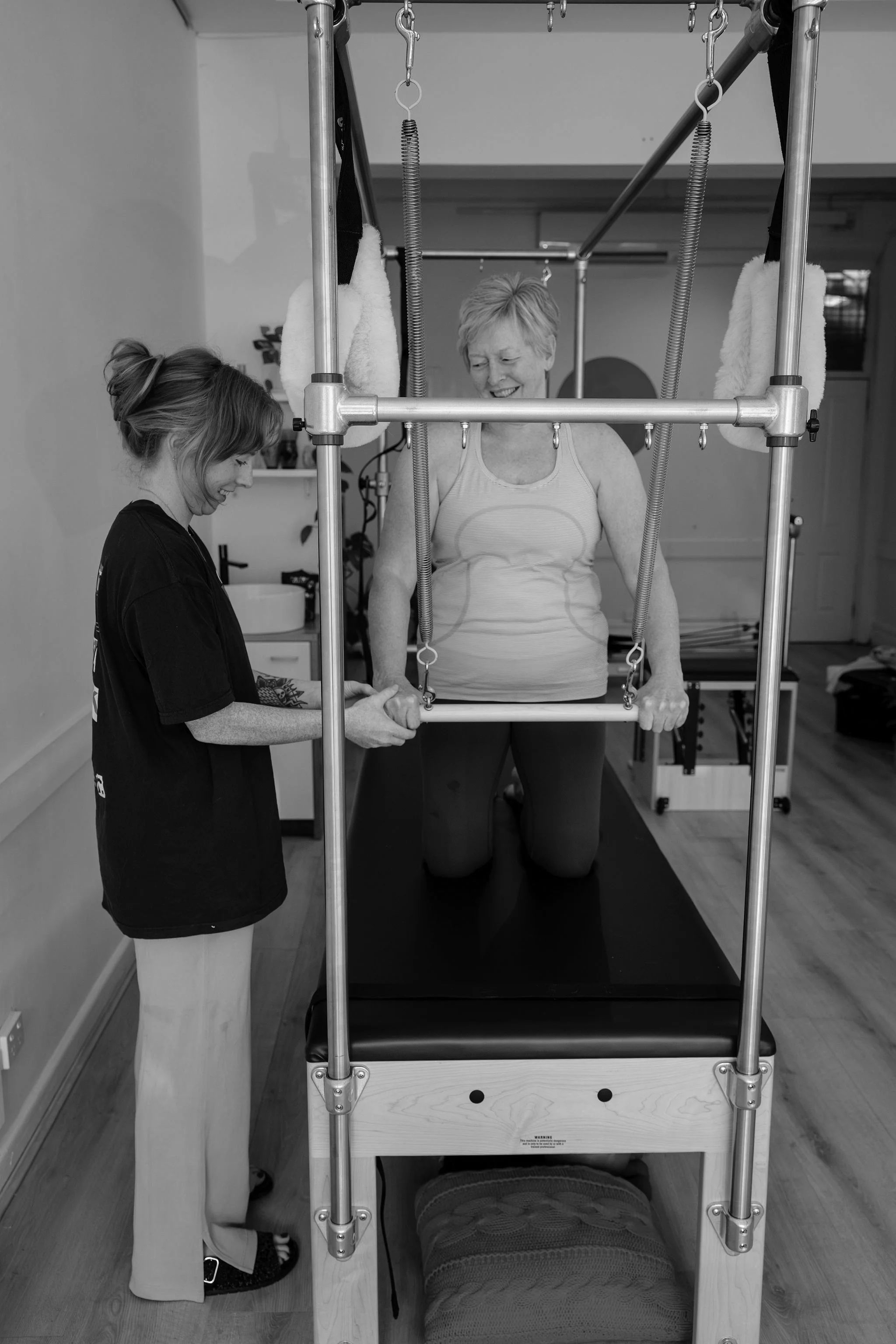 Instructor working one-on-one with a client within a semi-private Pilates class at Rosy Movement, Collingwood Melbourne