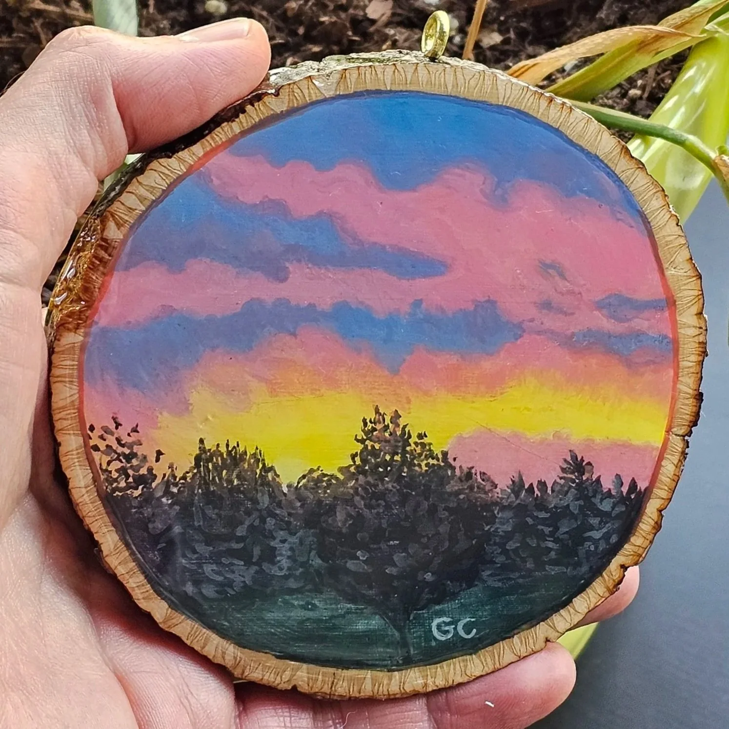 Sunrise on a wood cookie, gouache and resin, 2023
