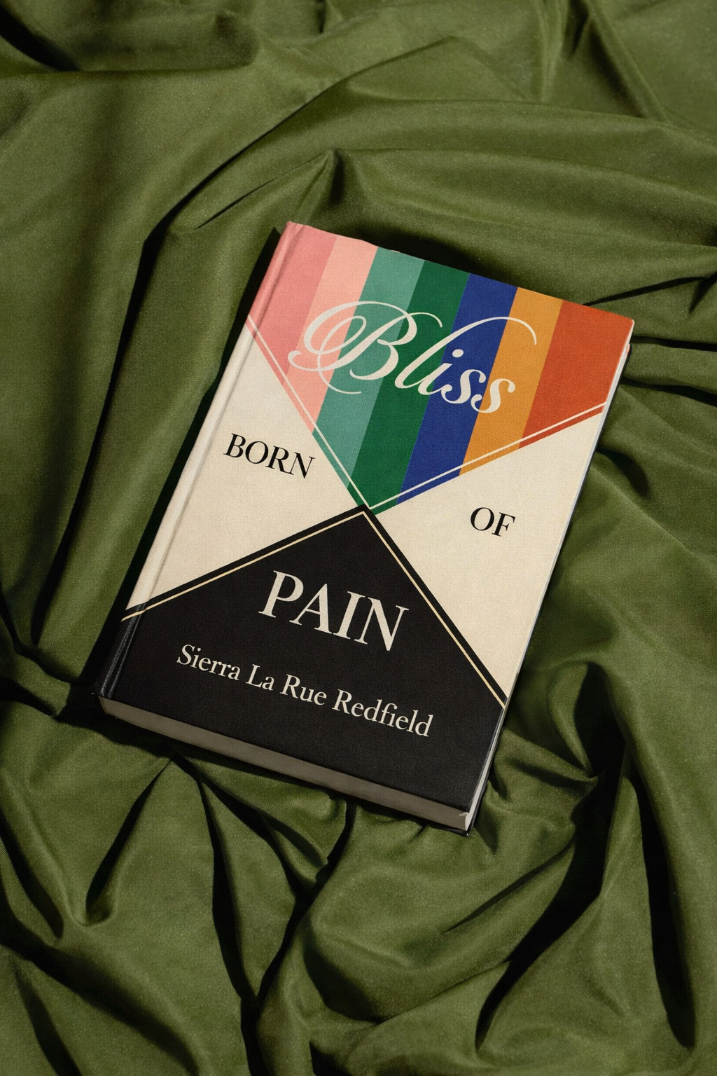 Bliss Born of Pain by Sierra La Rue Redfield resting on olive-green fabric.