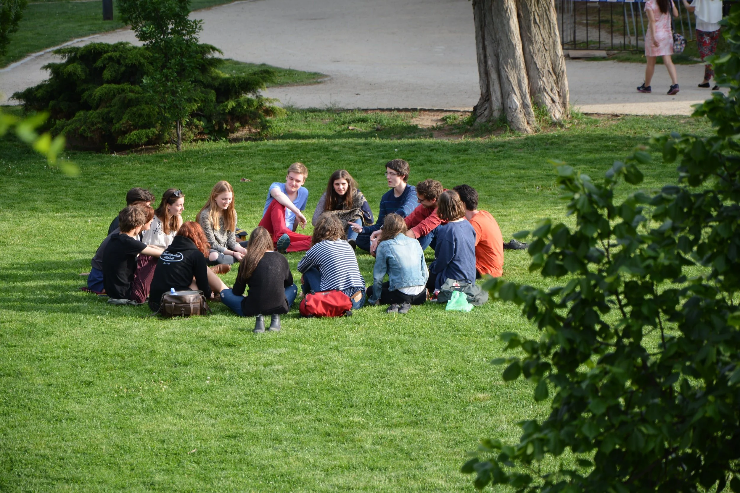 Young people sitting in circle on grass