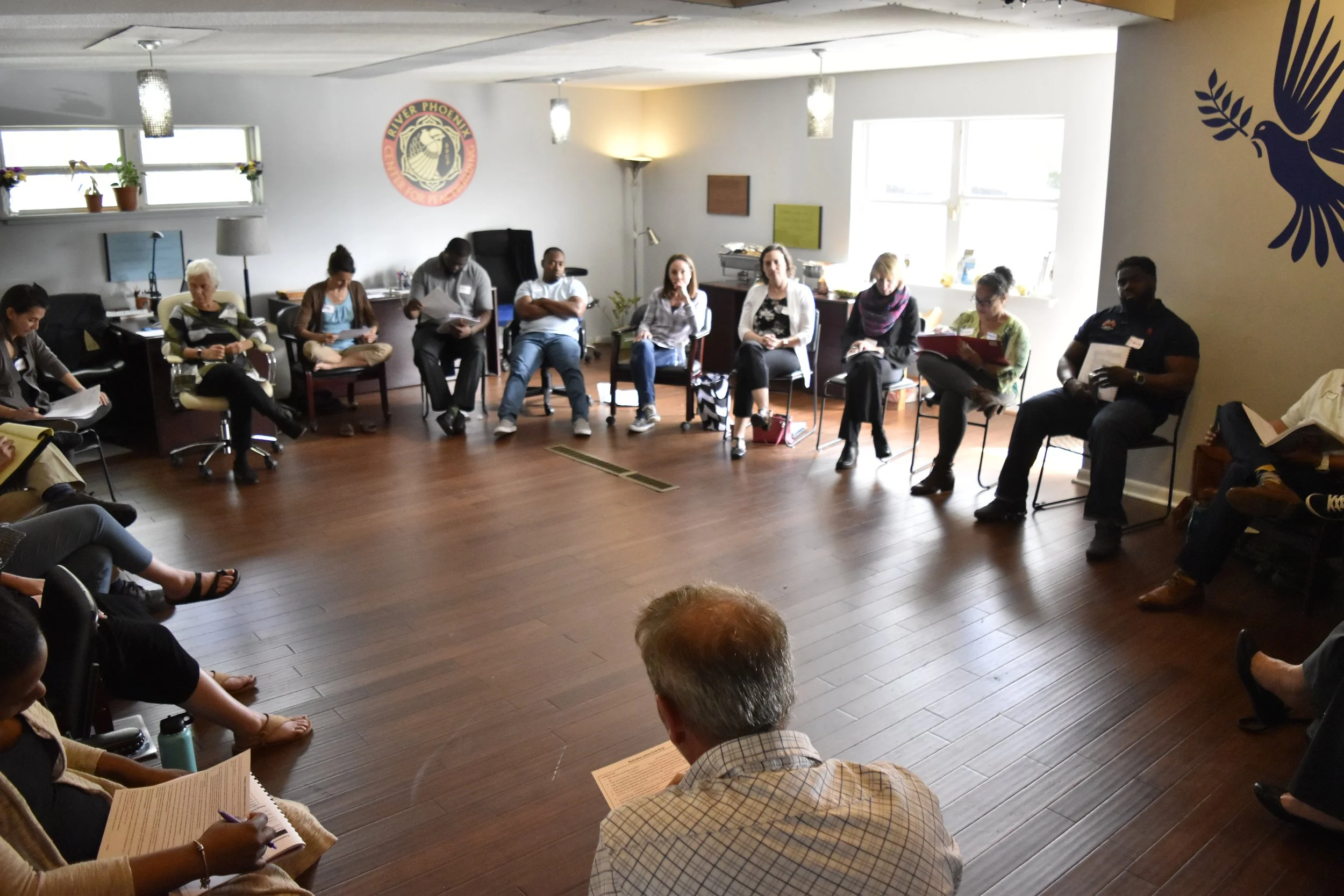 Participants seated in large circle during restorative justice training workshop
