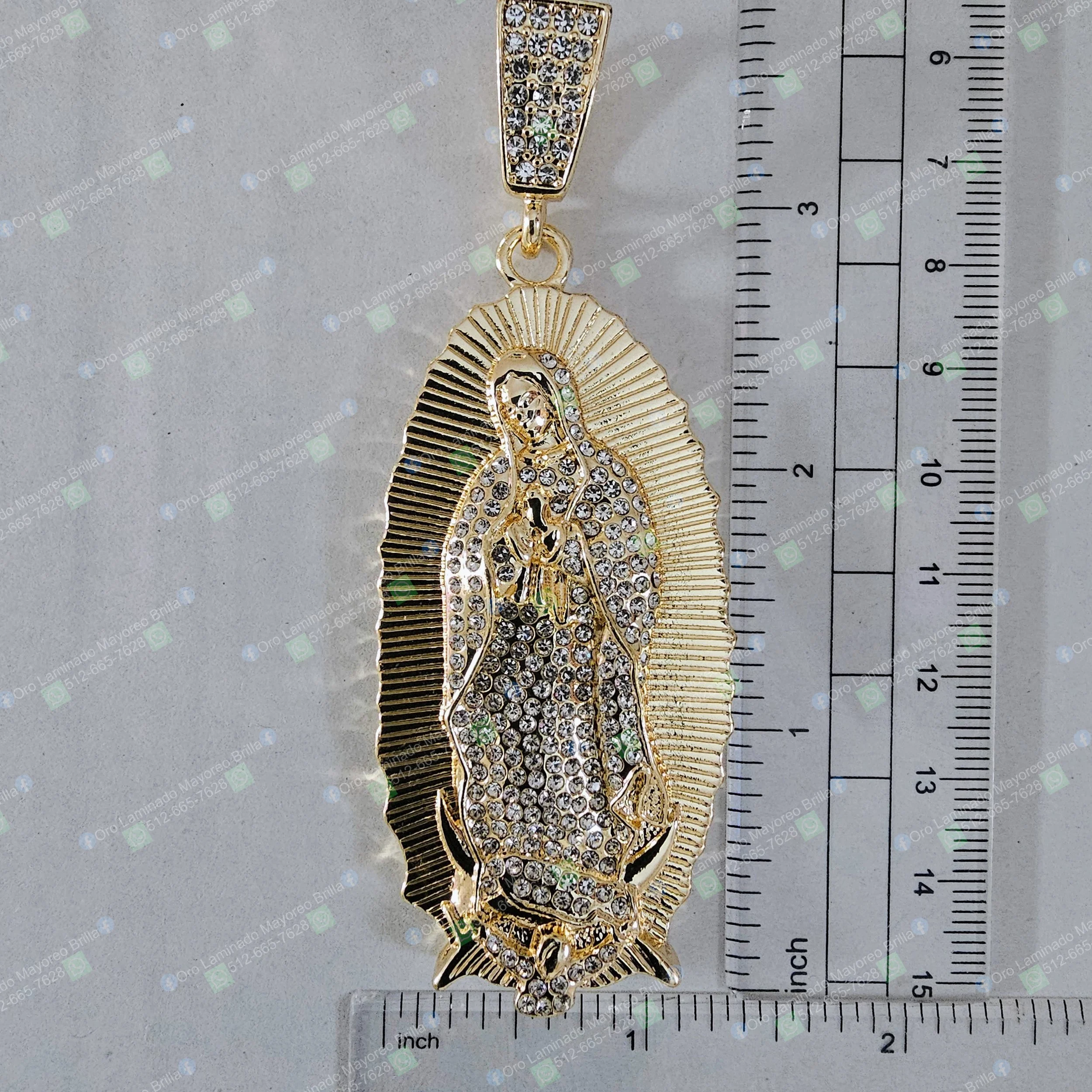 Dije Virgen de Guadalupe color oro con piedras decorativas visibles en forma ovalada | Gold color Virgin of Guadalupe pendant with visible decorative stones and oval shape
