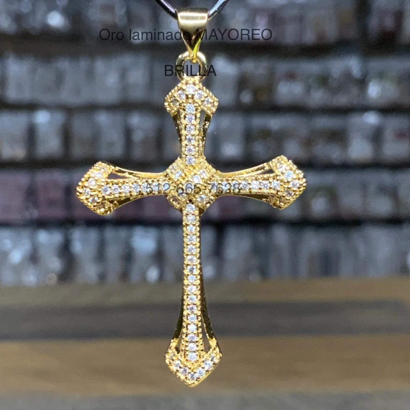 Cruz gótica con incrustaciones brillantes en oro laminado. Gothic cross with sparkling inlays in laminated gold.