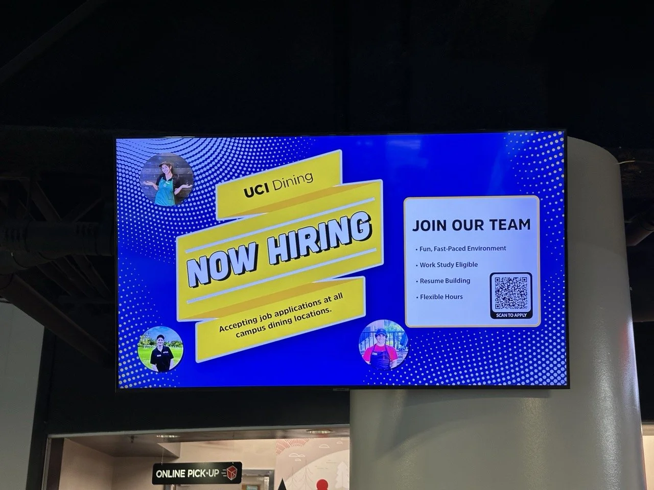 Digital sign advertising job openings at UCI Dining, highlighting benefits like a fun environment, work-study eligibility, resume building, and flexible hours, with a QR code for application.
