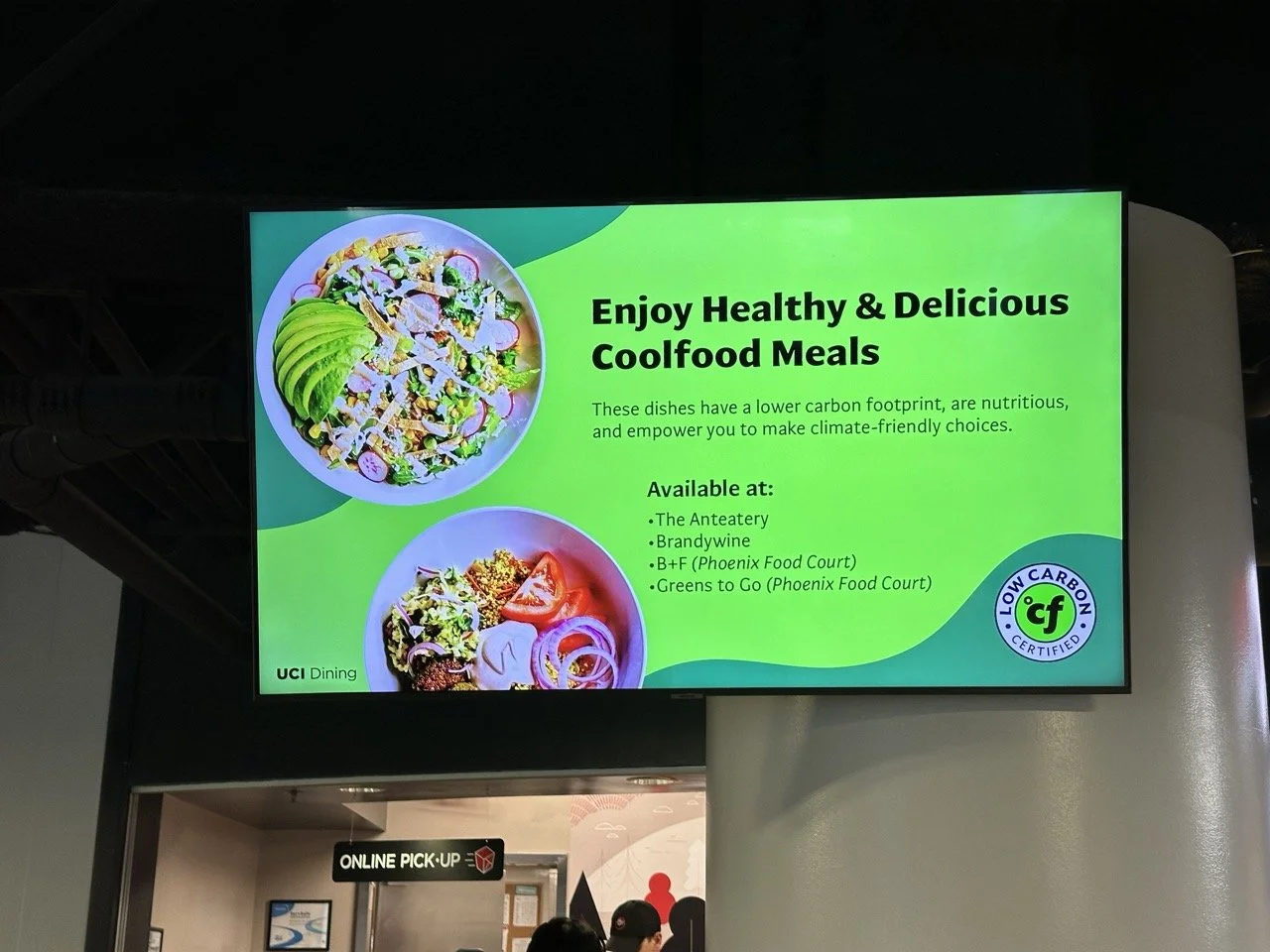 Digital menu promoting healthy, low-carb, plant-based meals with images of salads and bowls with vegetables and grains, listed at various campus dining locations.