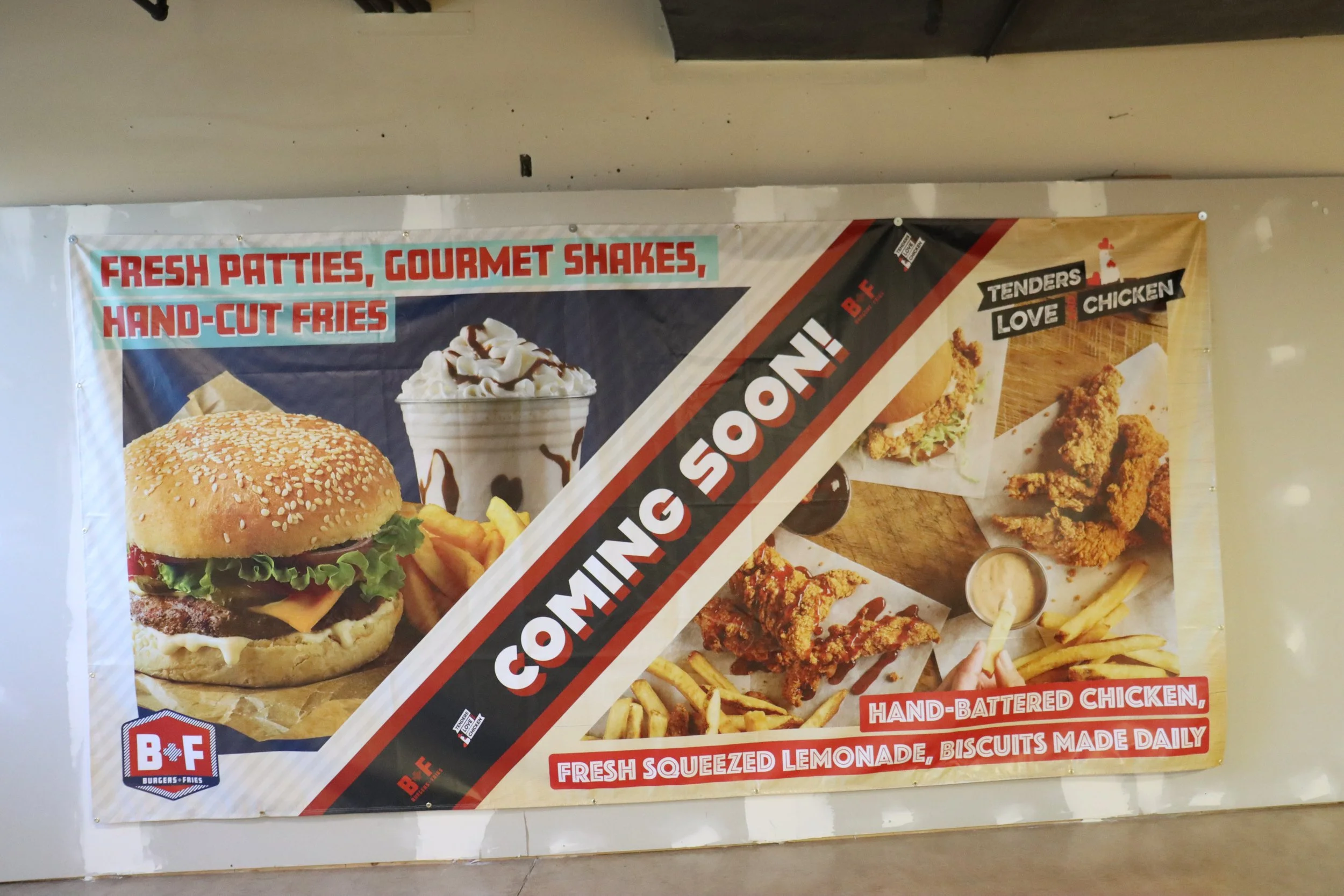 Advertisement banner featuring burger, fries, milkshake, and chicken wings, with text advertising freshly made patties, shakes, hand-cut fries, and hand-battered chicken.