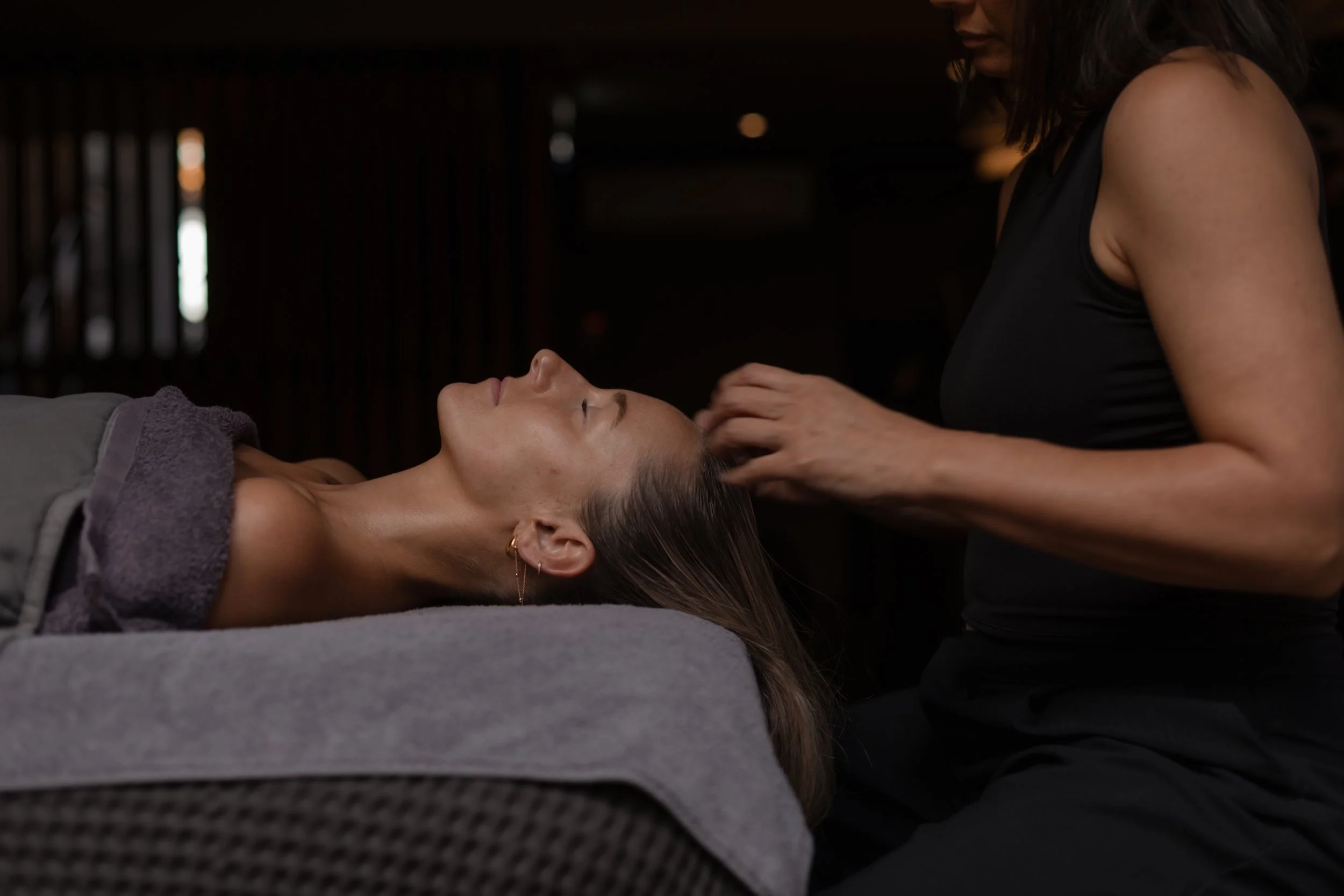 Woman receiving a head massage at a spa or wellness center.