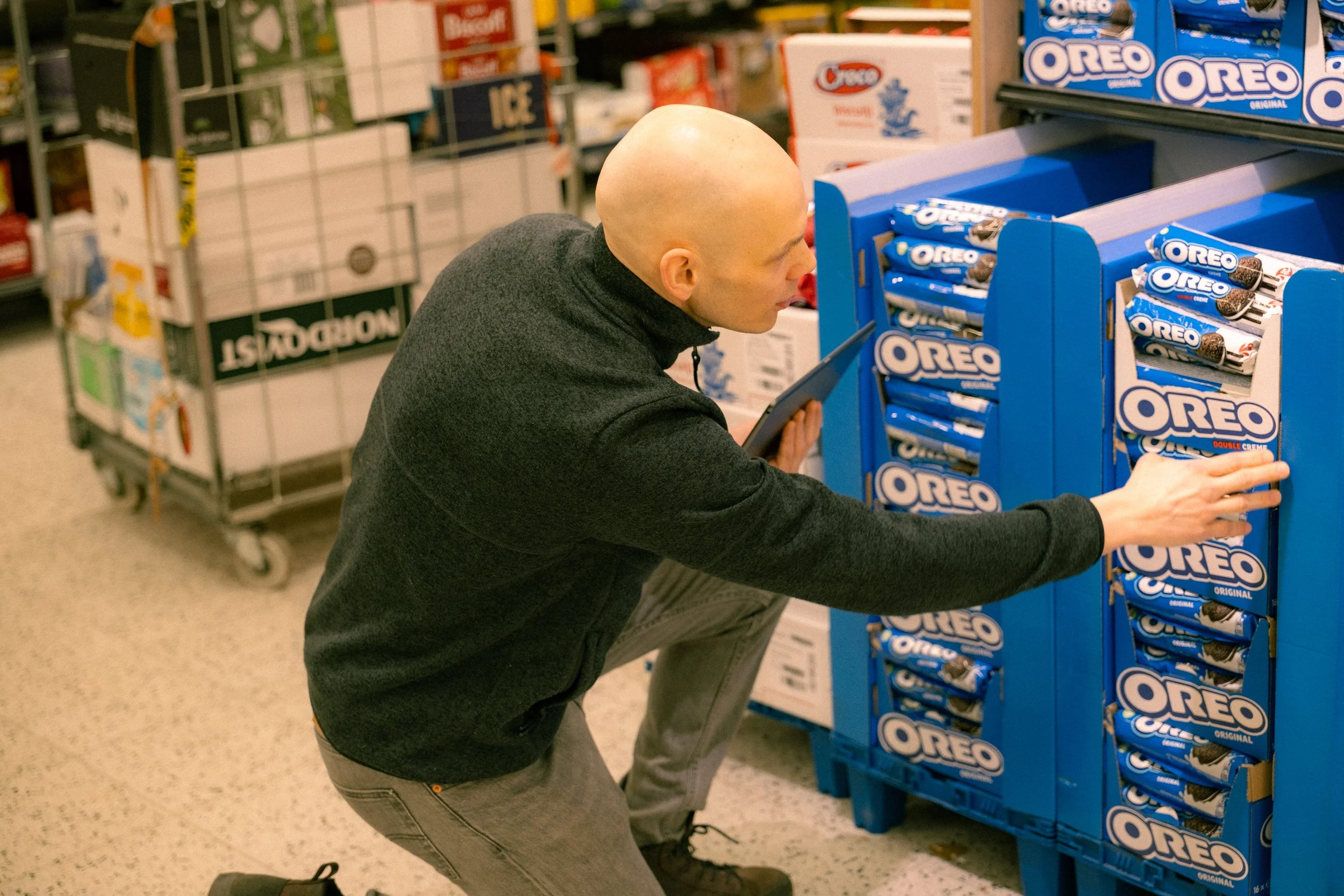 Field sales rep checking store compliance on a store display