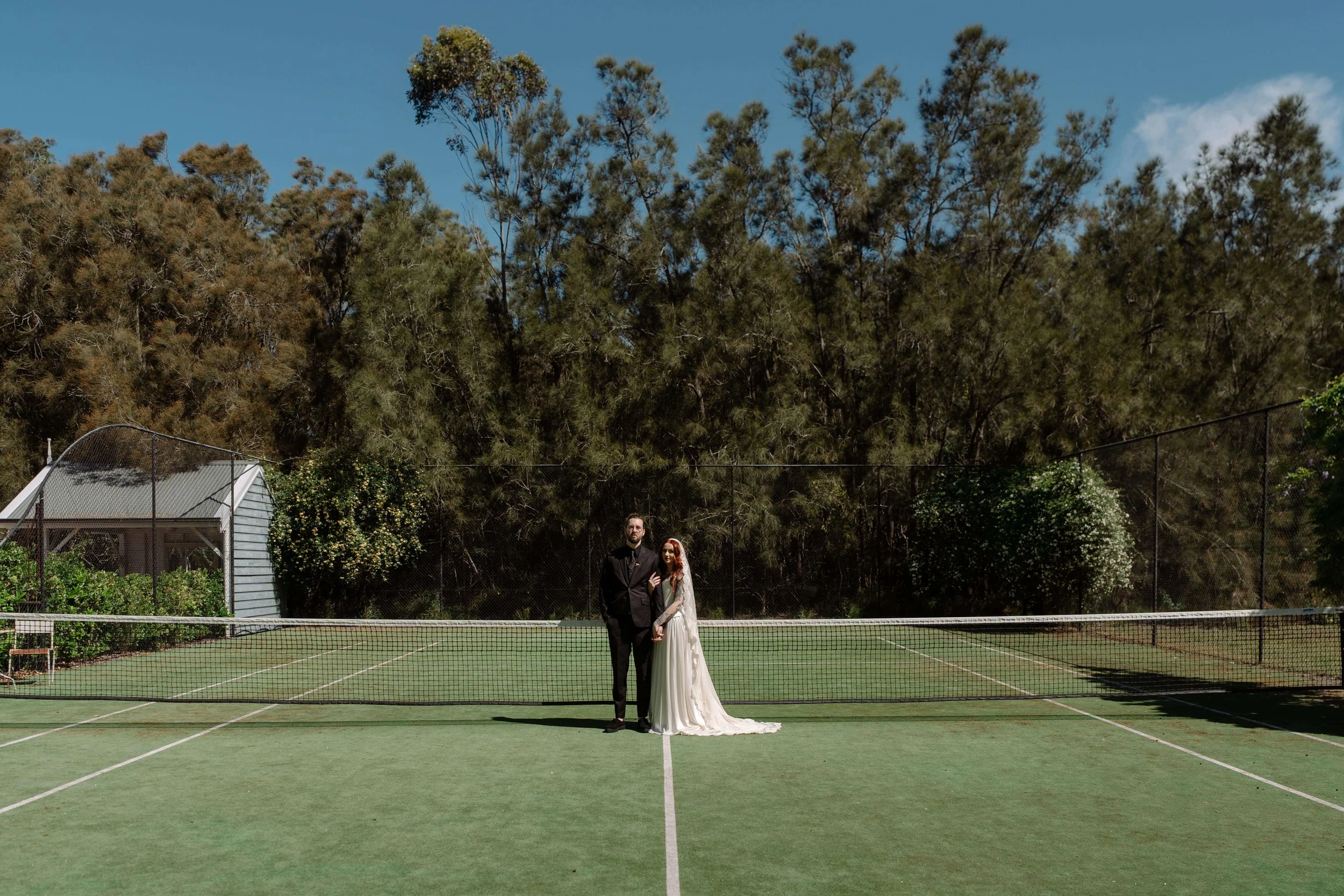 Bride and Groom during their first look on the grounds tennis court at Circa 1876