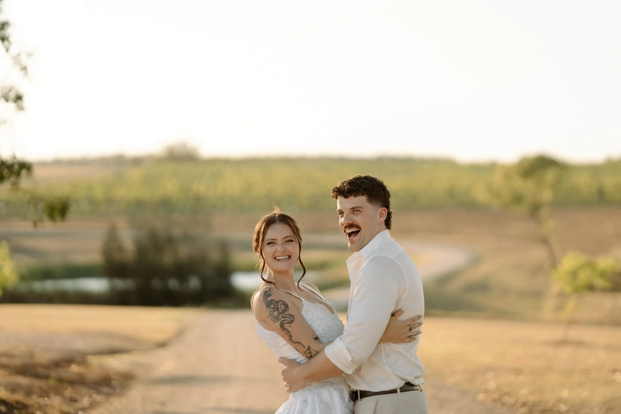 Newlyweds photographed laughing at Squires Vineyard in the Hunter Valley