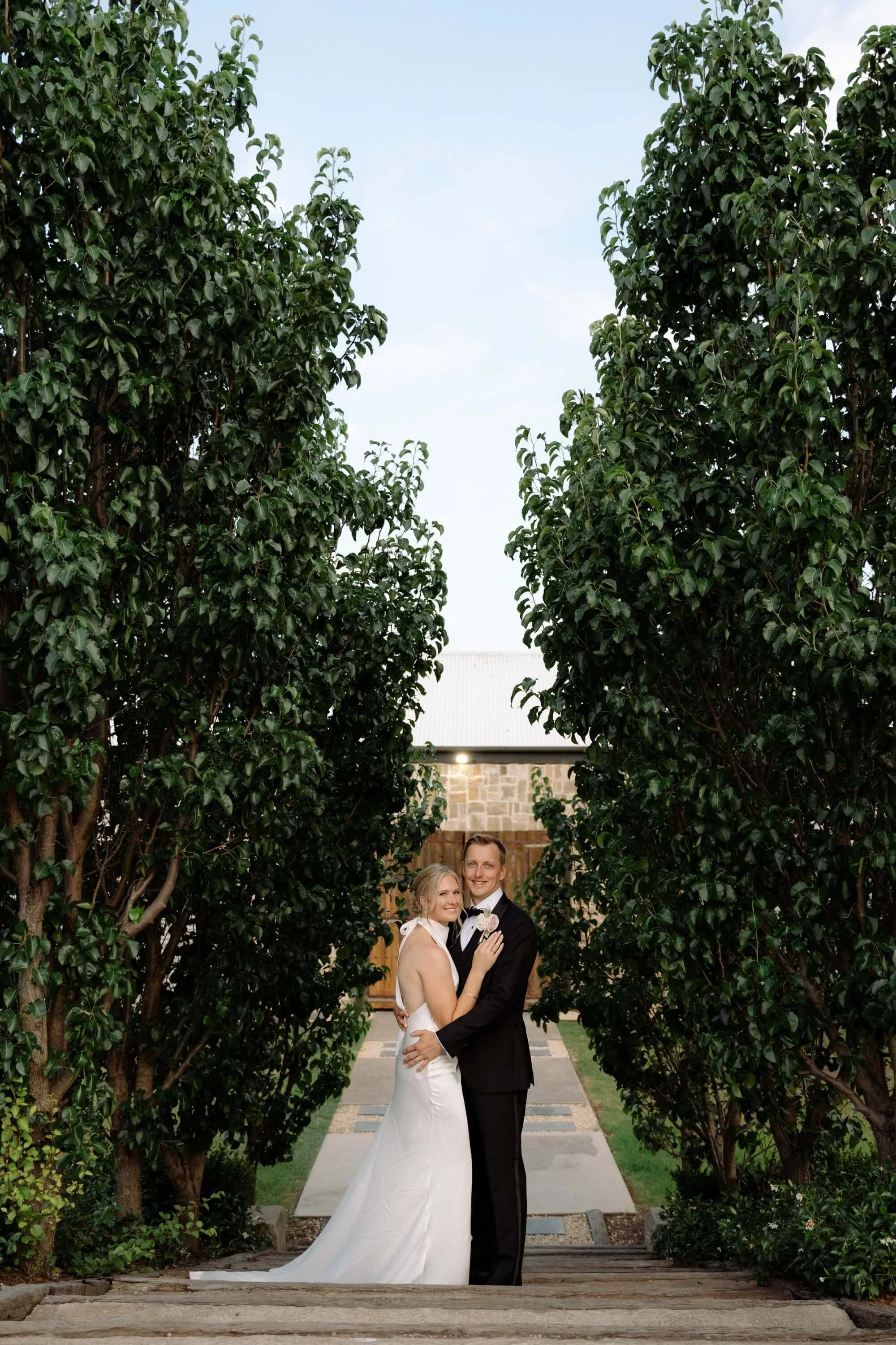 Bride & Groom on the steps at Bimbadgen Palmers Lane