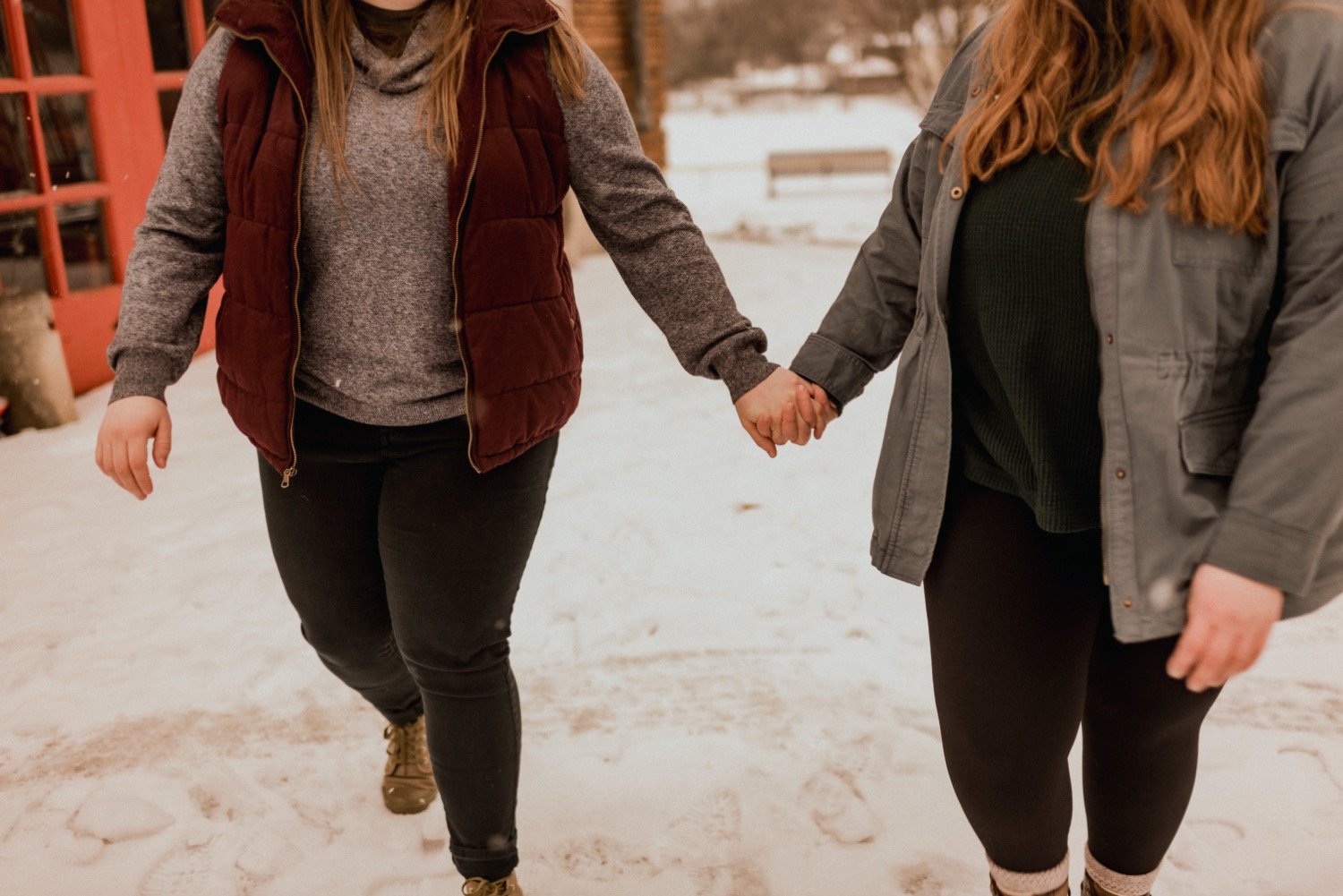 Couple-holds-hands-while-walking-through-the-snow.jpg.jpg