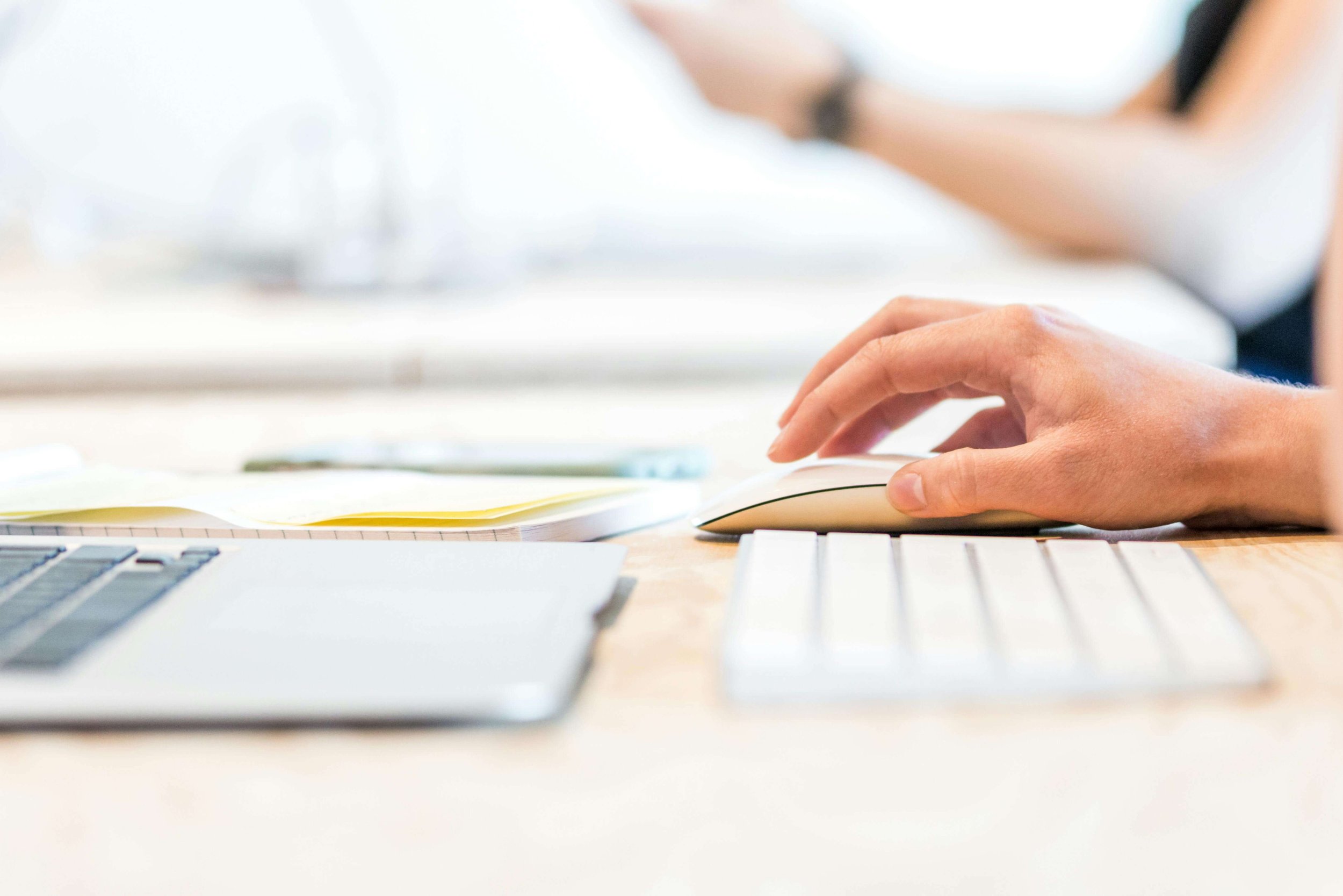 Image of a person's hand using a mouse and clicking it.