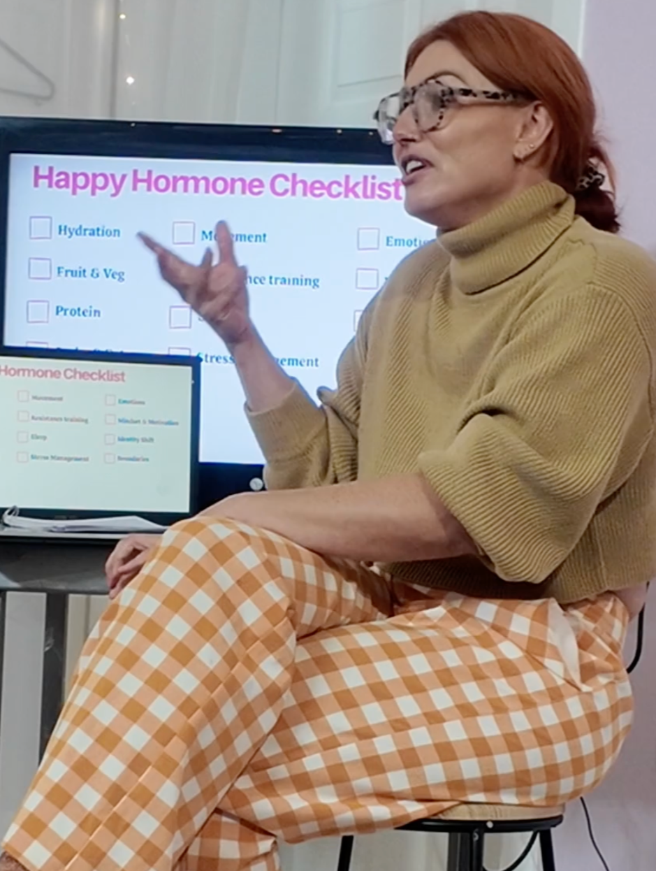 Woman with red hair and glasses teaching hormones