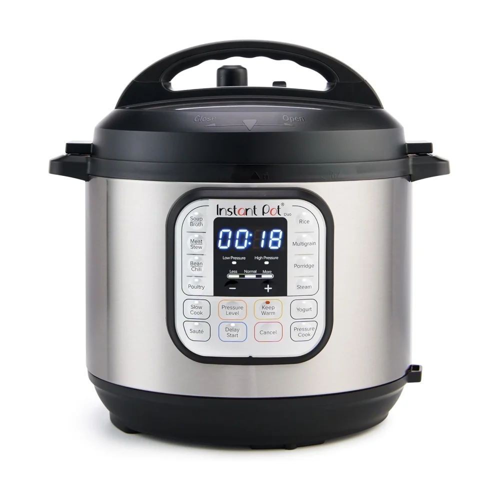 Stainless steel electric pressure cooker on a white background