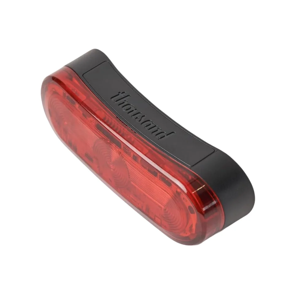 Helmet light: Compact red magnetic rear safety light that clicks onto a helmet for visibility on low-light rides.