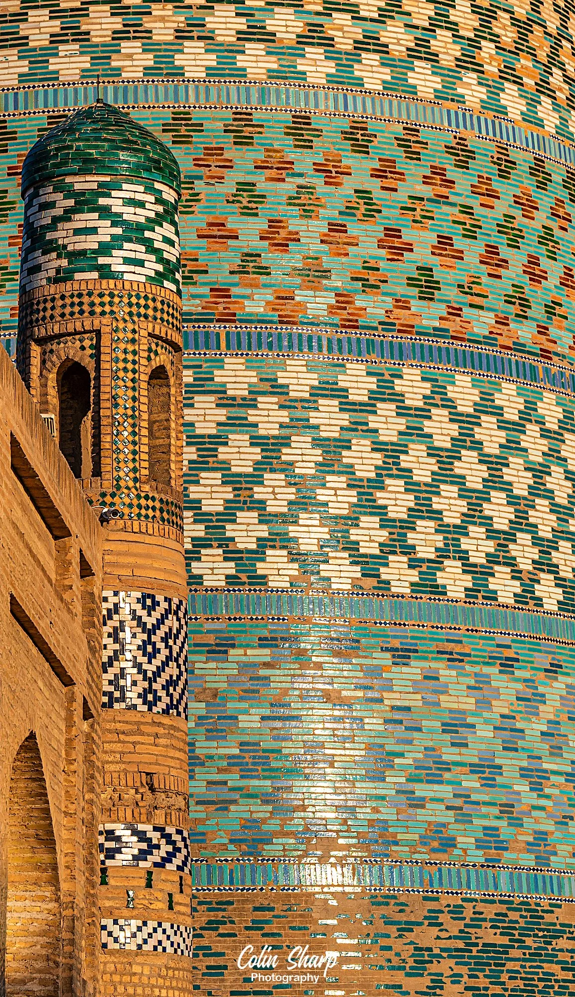 A pattern image using the turquoise tiles and mosaics of the Kalta Minor Minaret as the background.