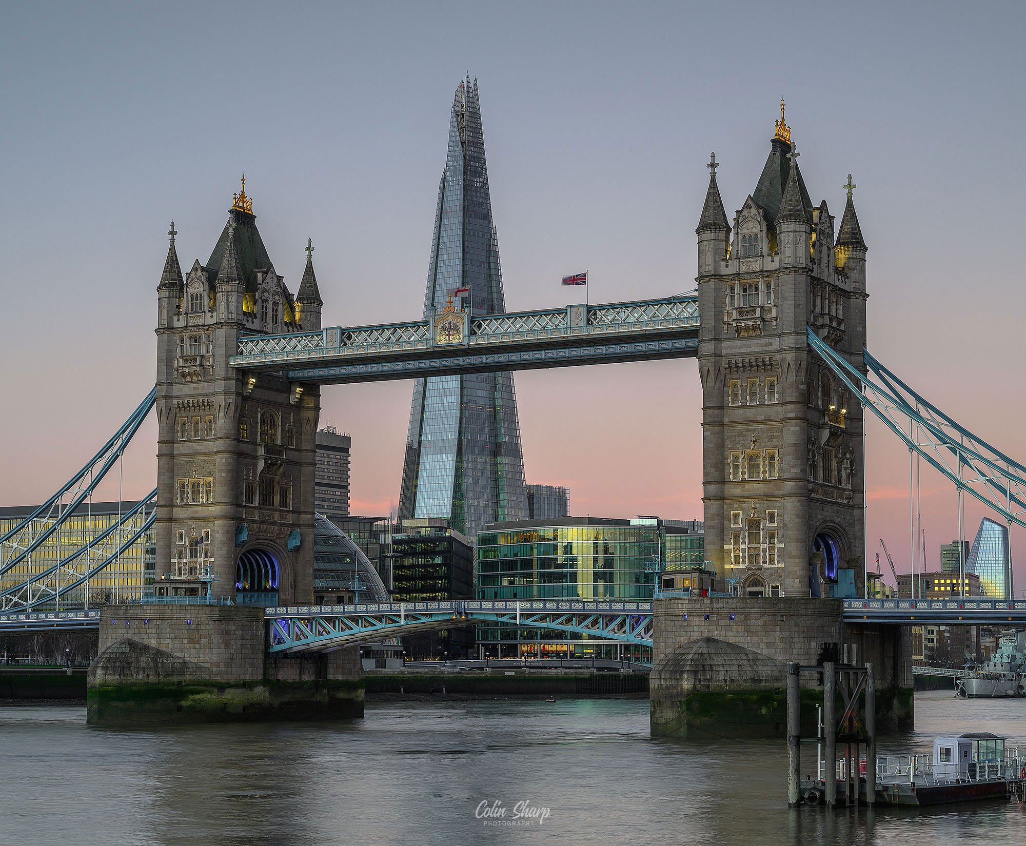 View of Tower Bridge over the River Thames with the Shard skyscraper in the background at at the start of the morning golden hour