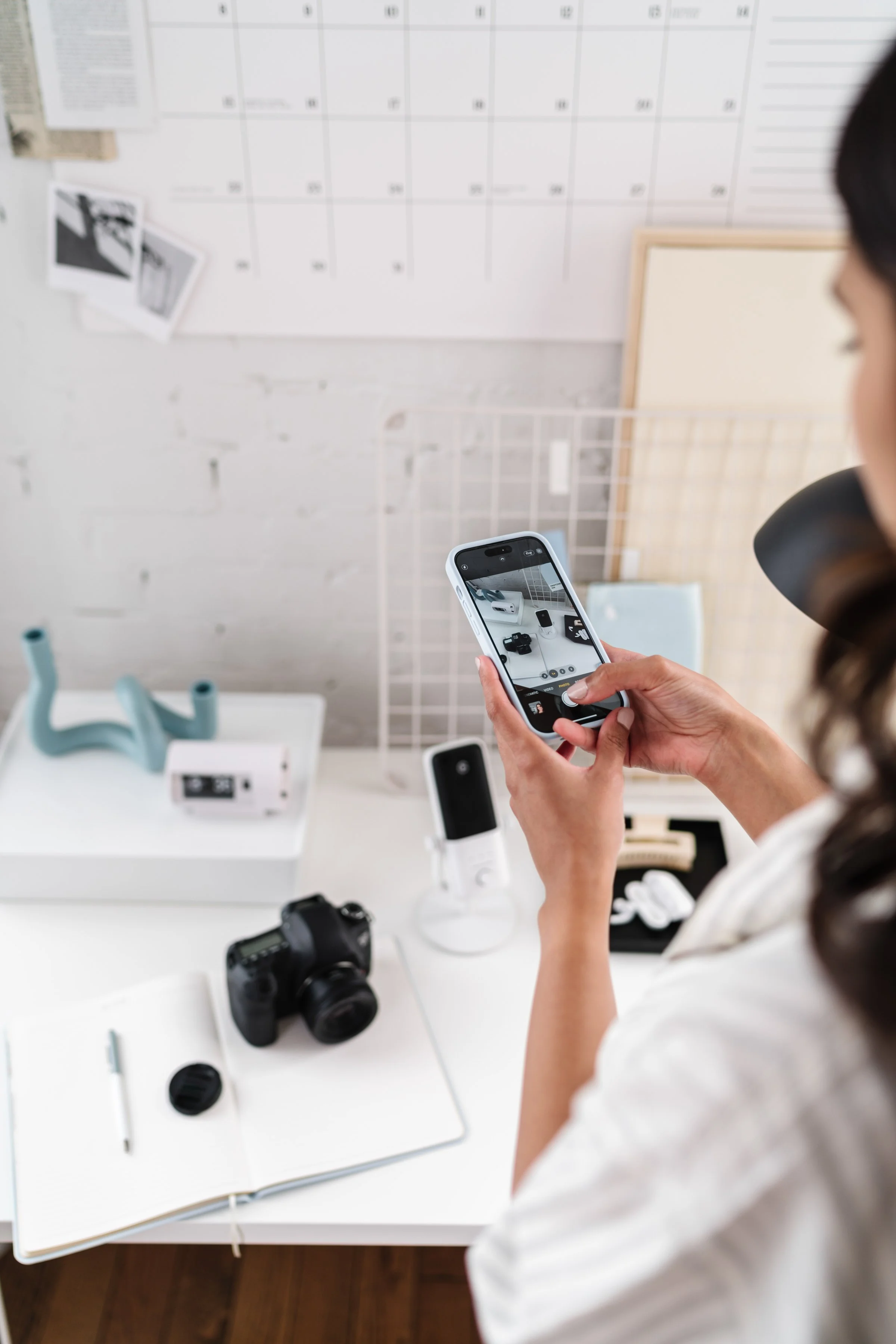 Woman taking picture of her cute desk setup