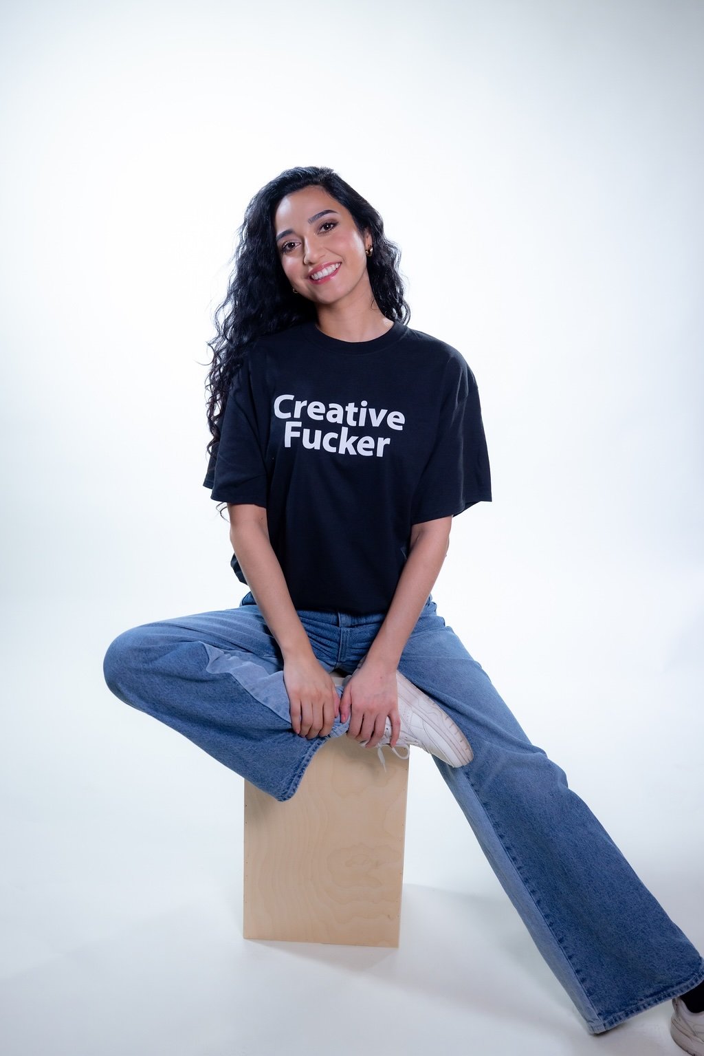 Female sitting down wearing Creative Fucker T shirt