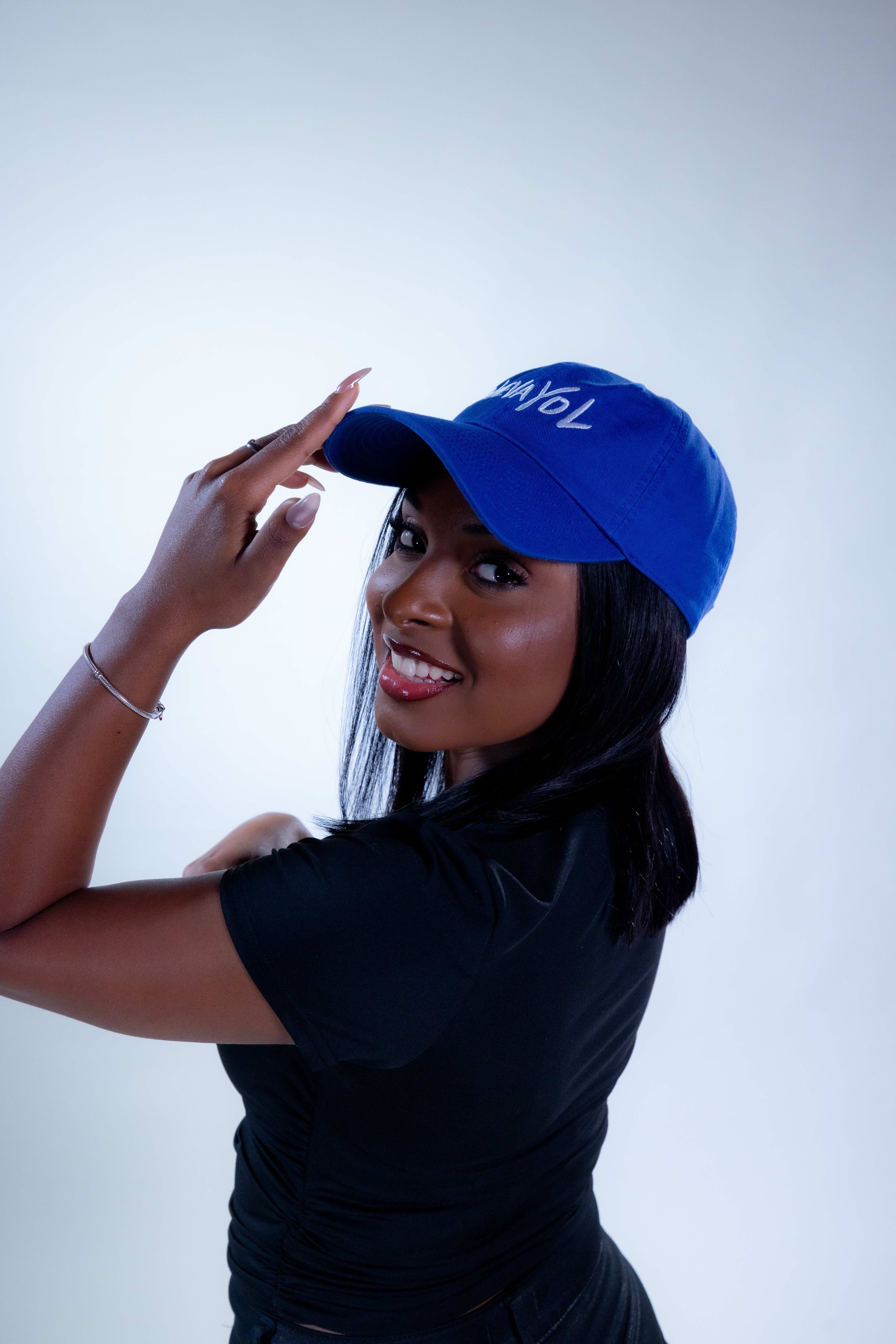 Girl wearing the Nuevayol Hat smiling