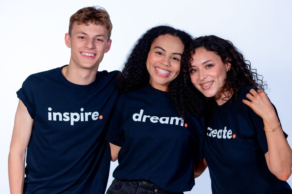 male and two females wearing the inspire.dream.create t shirt by 787 coffee