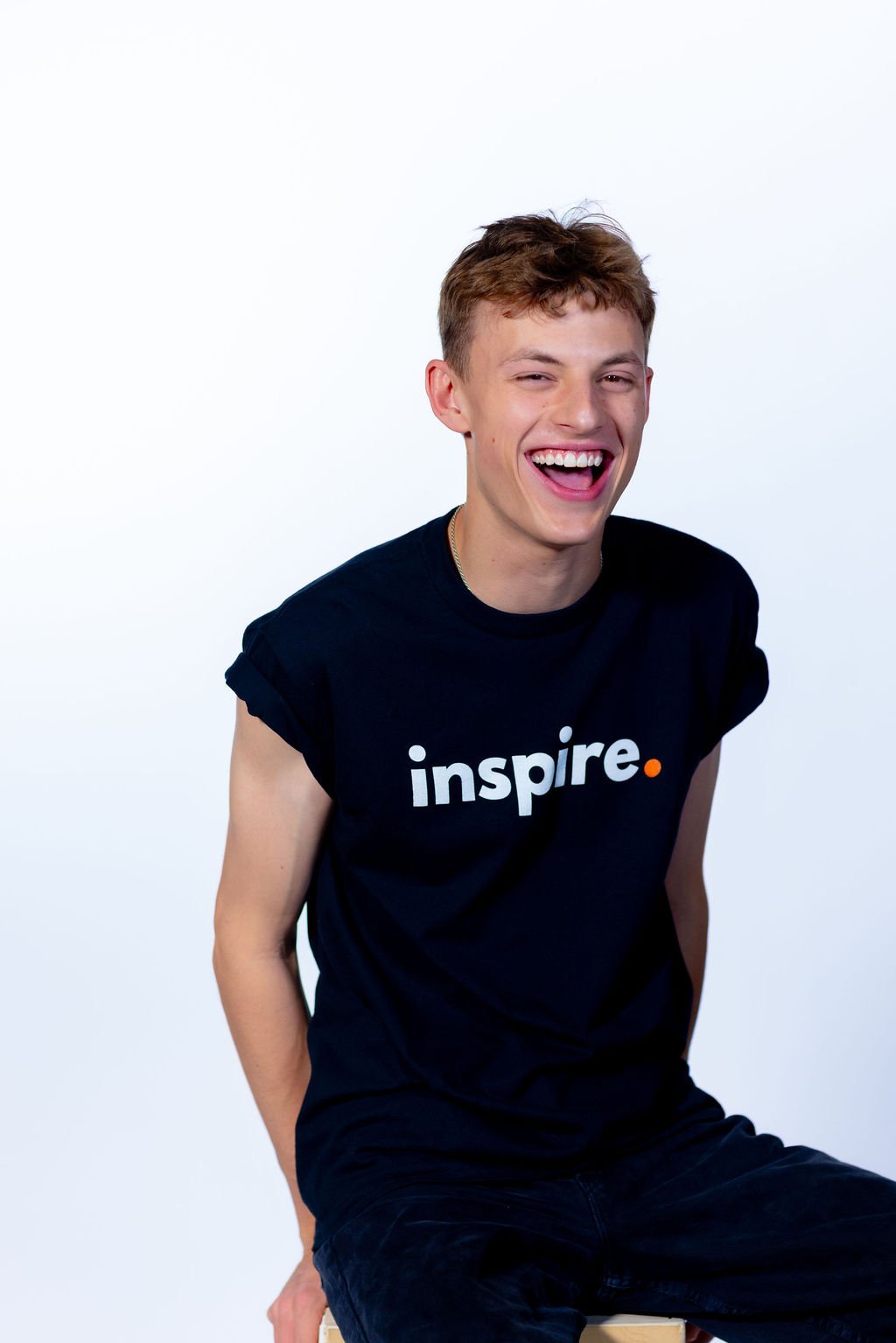 male wearing the black cotton tshirt- with bold white letter and orange point-787 coffee
