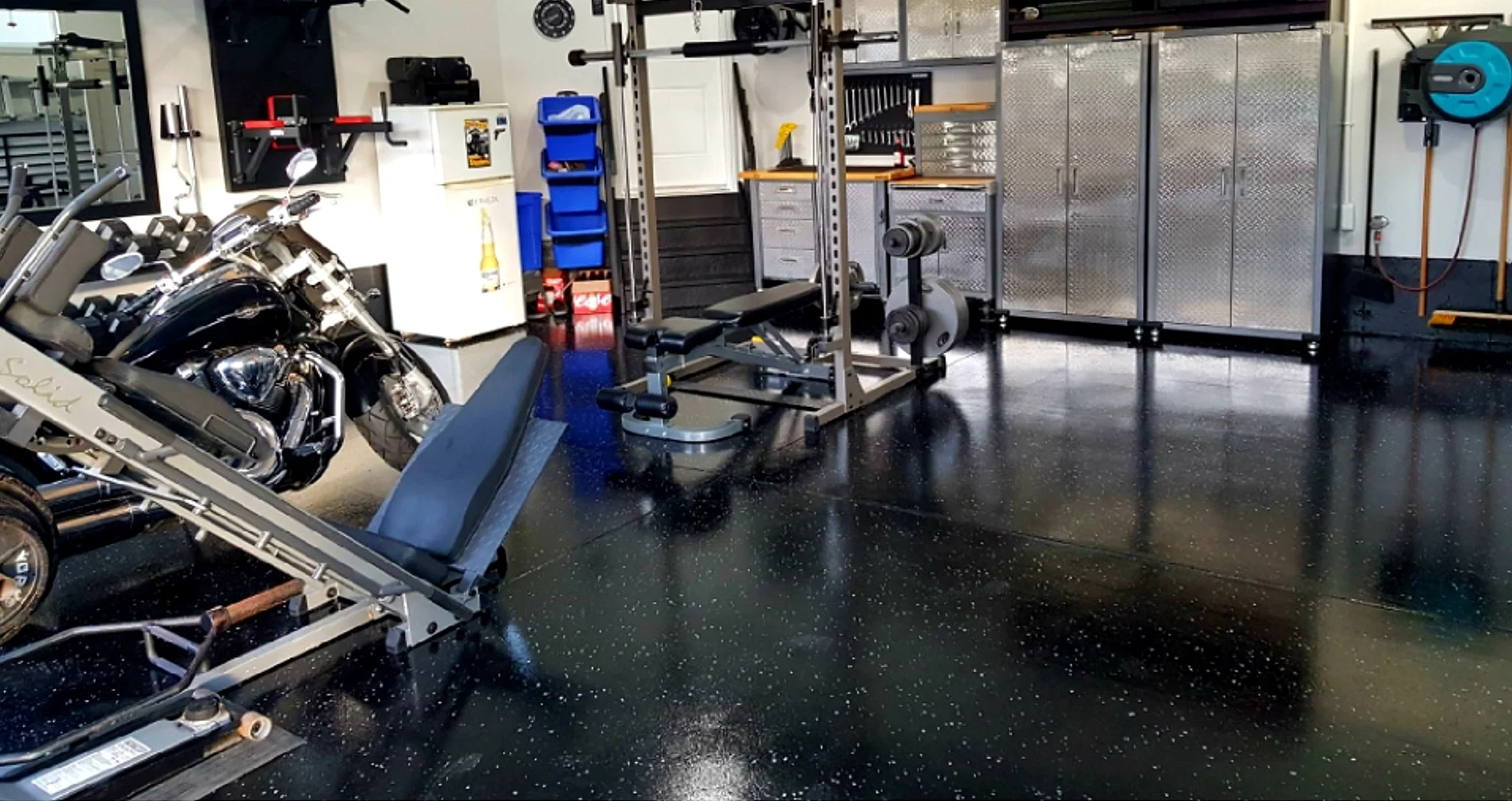 Black epoxy floor with minimal flake broadcast.