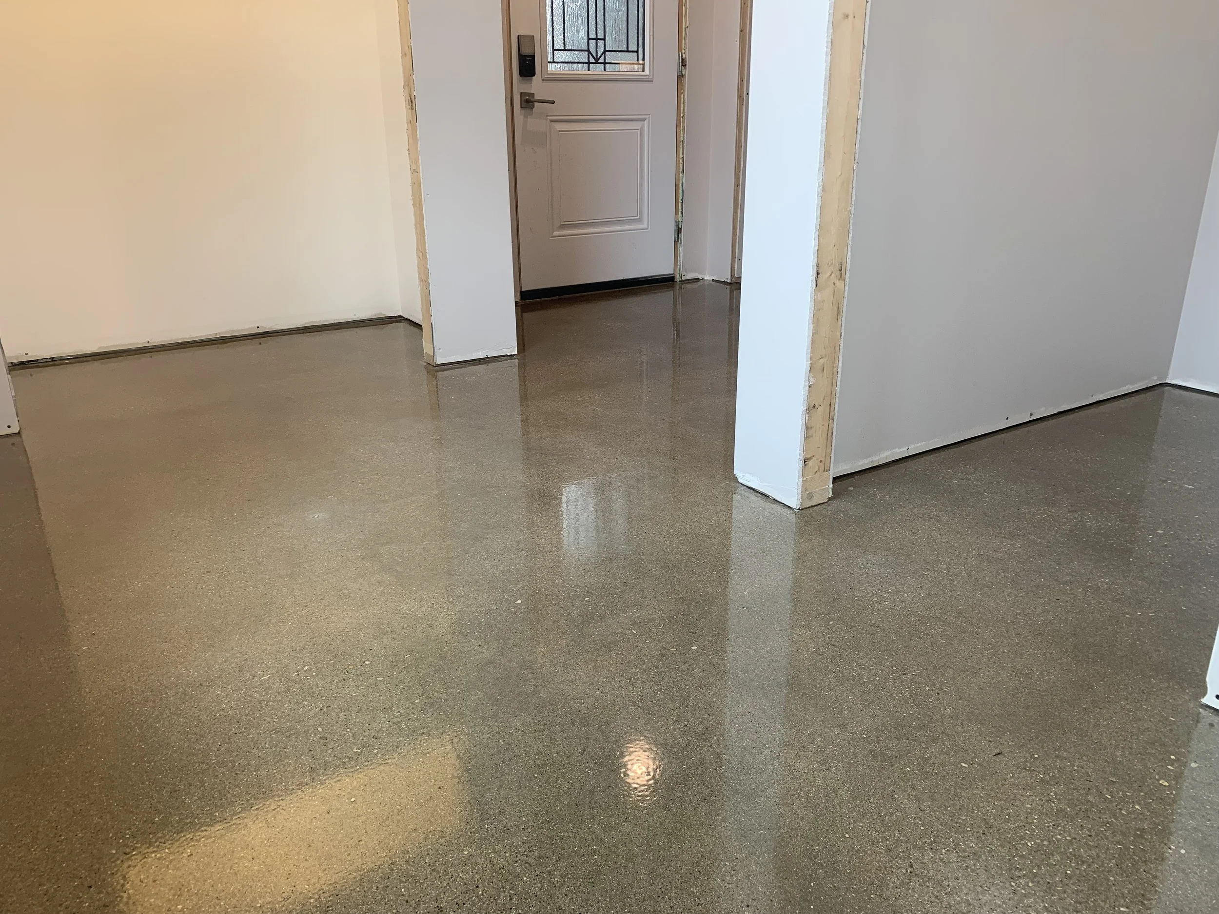 Clear epoxy over polished concrete in a mudroom with a UV resistent top coat