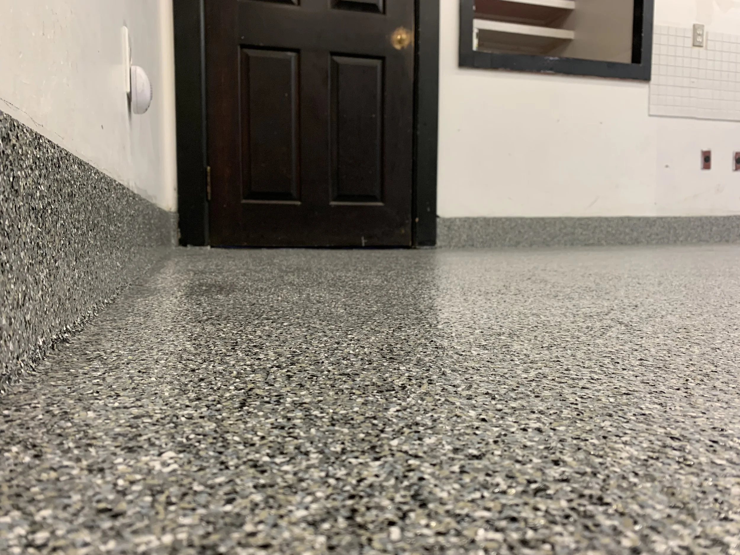 Granite paint flake floor system with matching wall trim