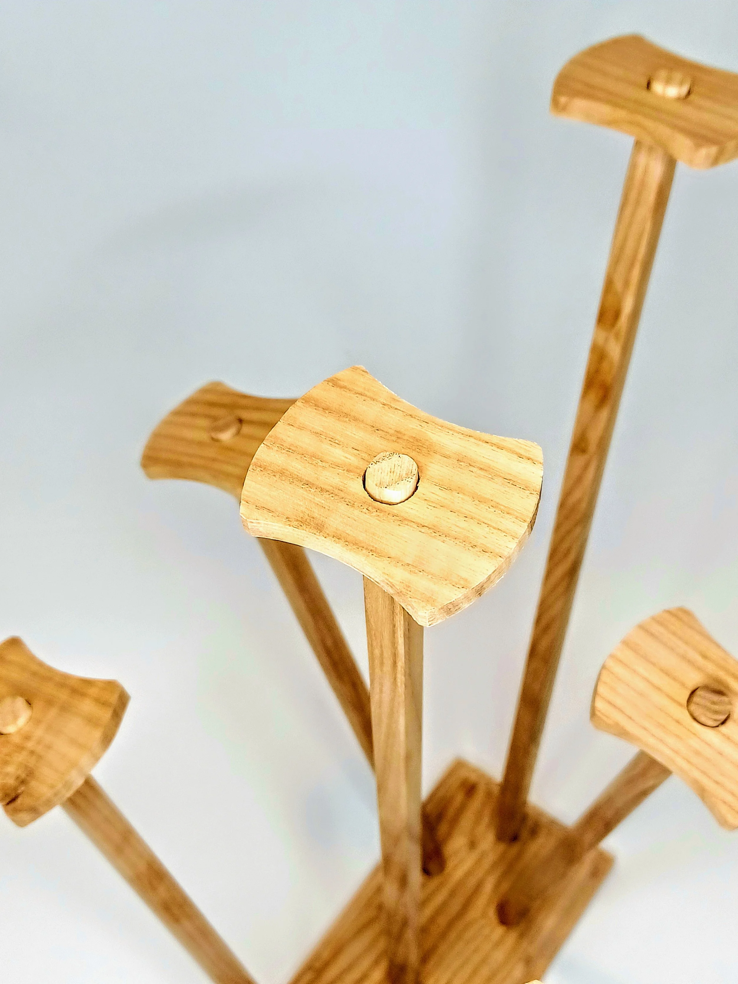 Close-up of a wooden product made for keeping plastic bags open during drying.