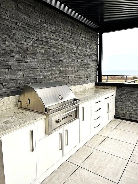 The roof deck has a gas grill with custom cabinets and marble countertops.