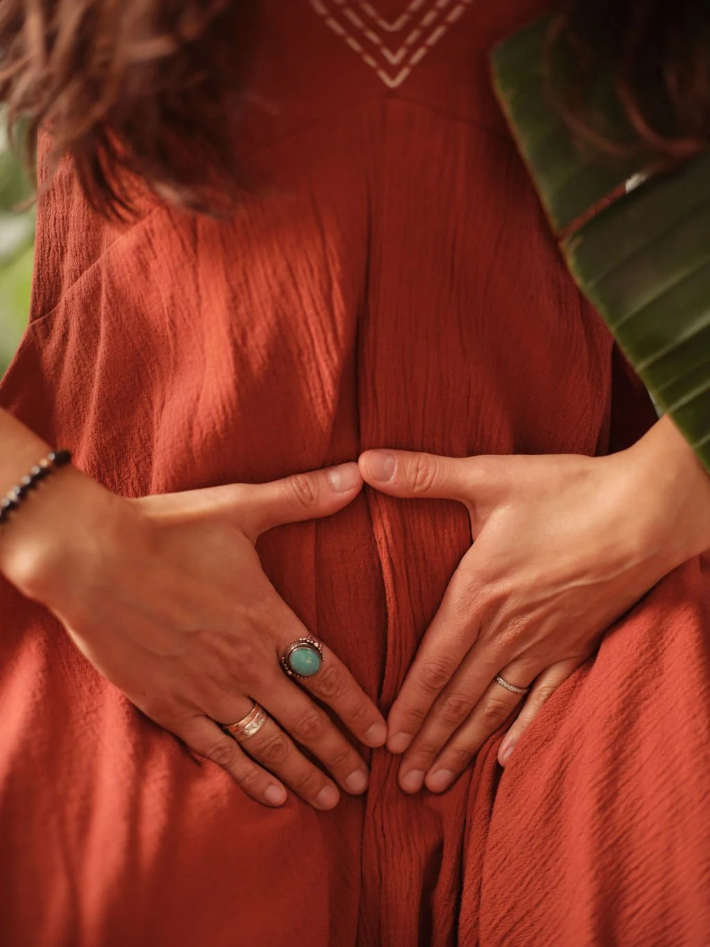 A woman holding her womb space with both hands.