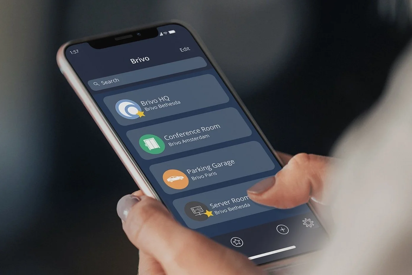 Person holding phone showing Brivo app interface