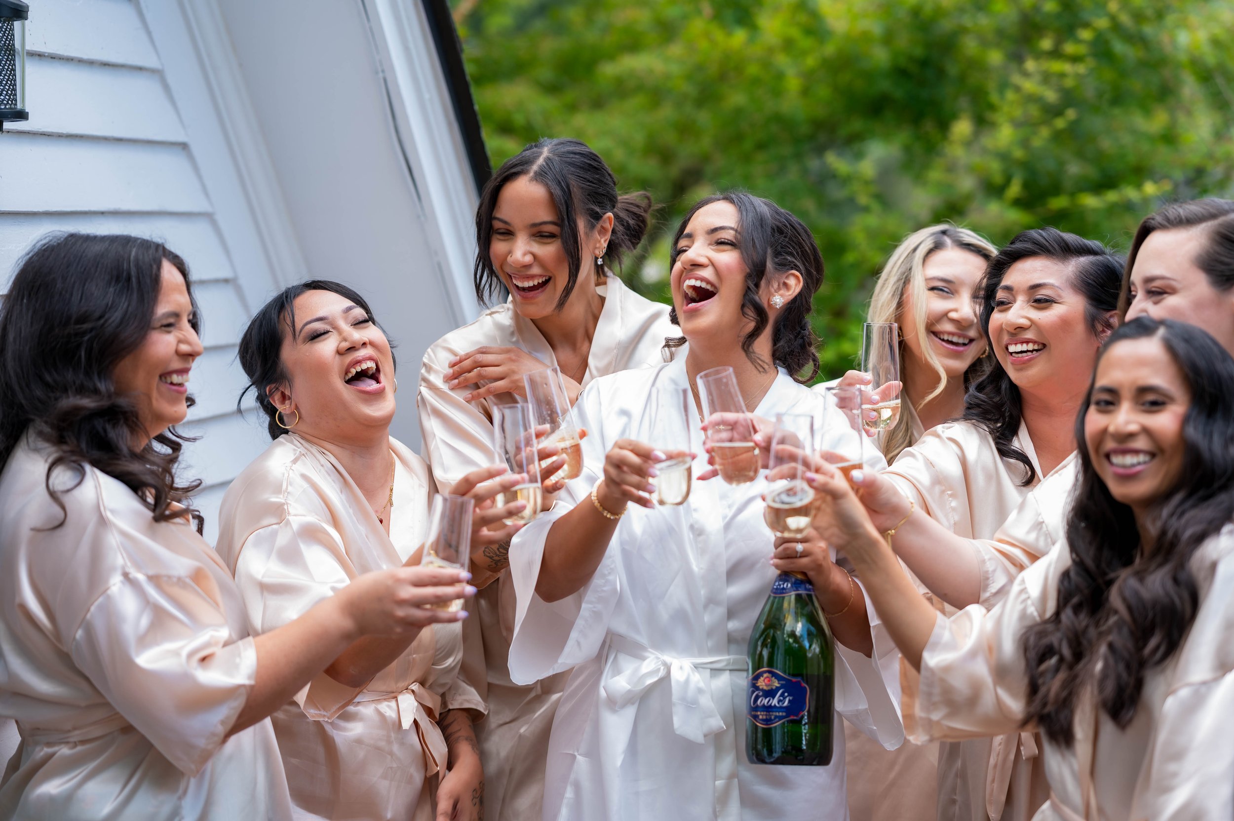 Bridesmaids laughing and toasting with champagne, candid documentary wedding photographer Federal Way