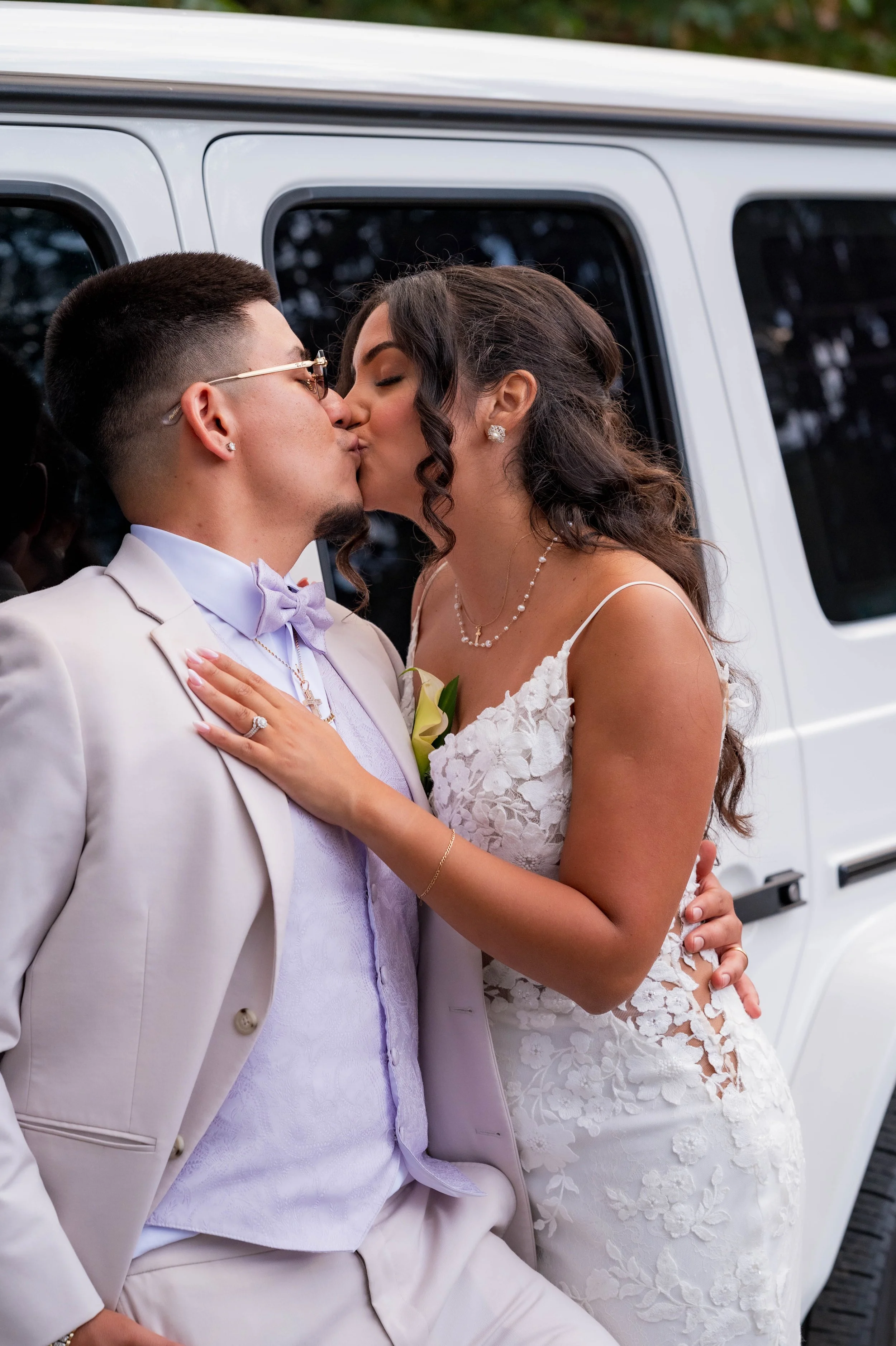 bride and groom kissing beside a white SUV, Documentary wedding photography collections starting at $3900 in seattle and tacoma
