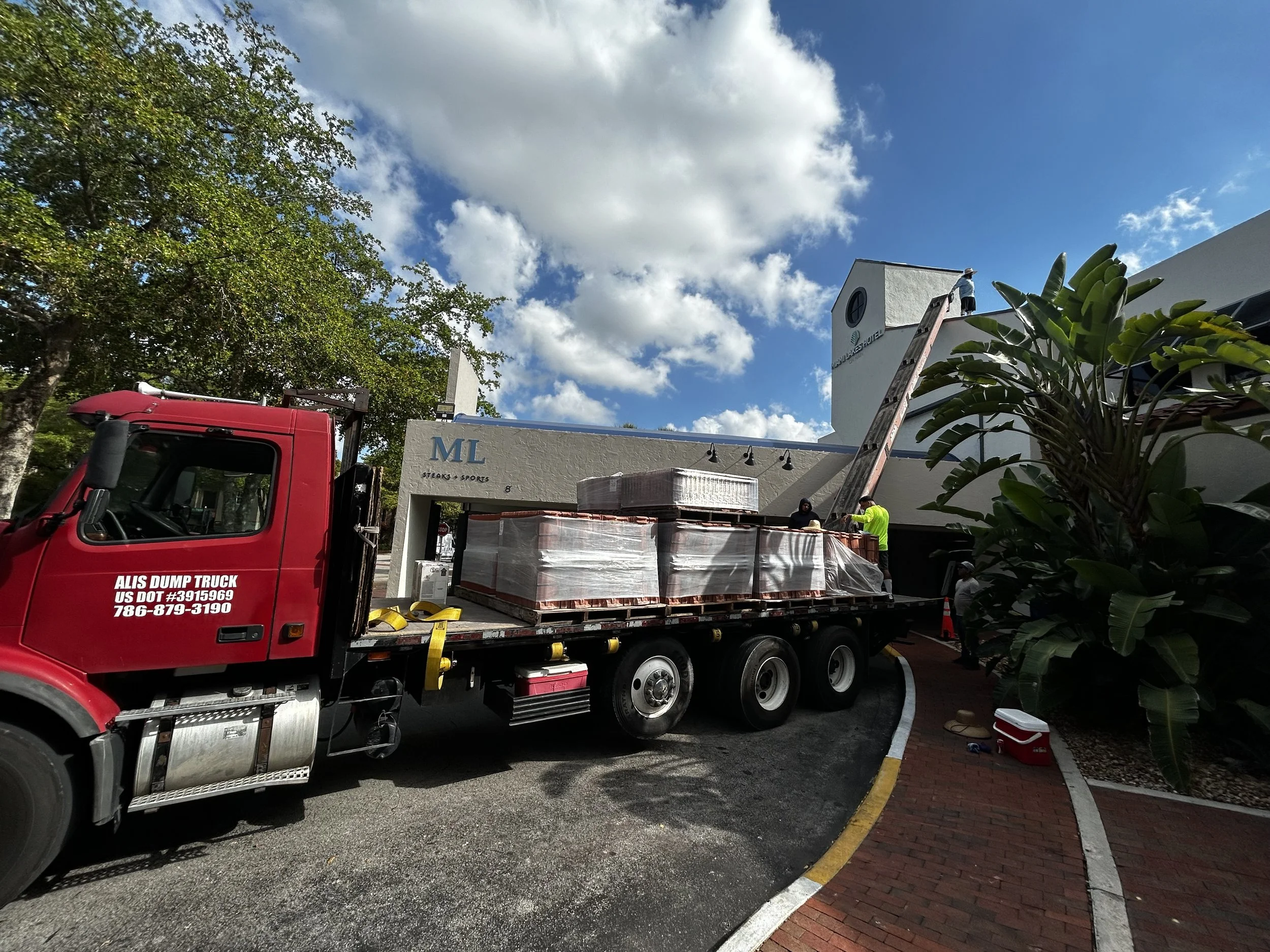Reroof in progress at Miami Lakes Hotel. Roof tile delivery + placement