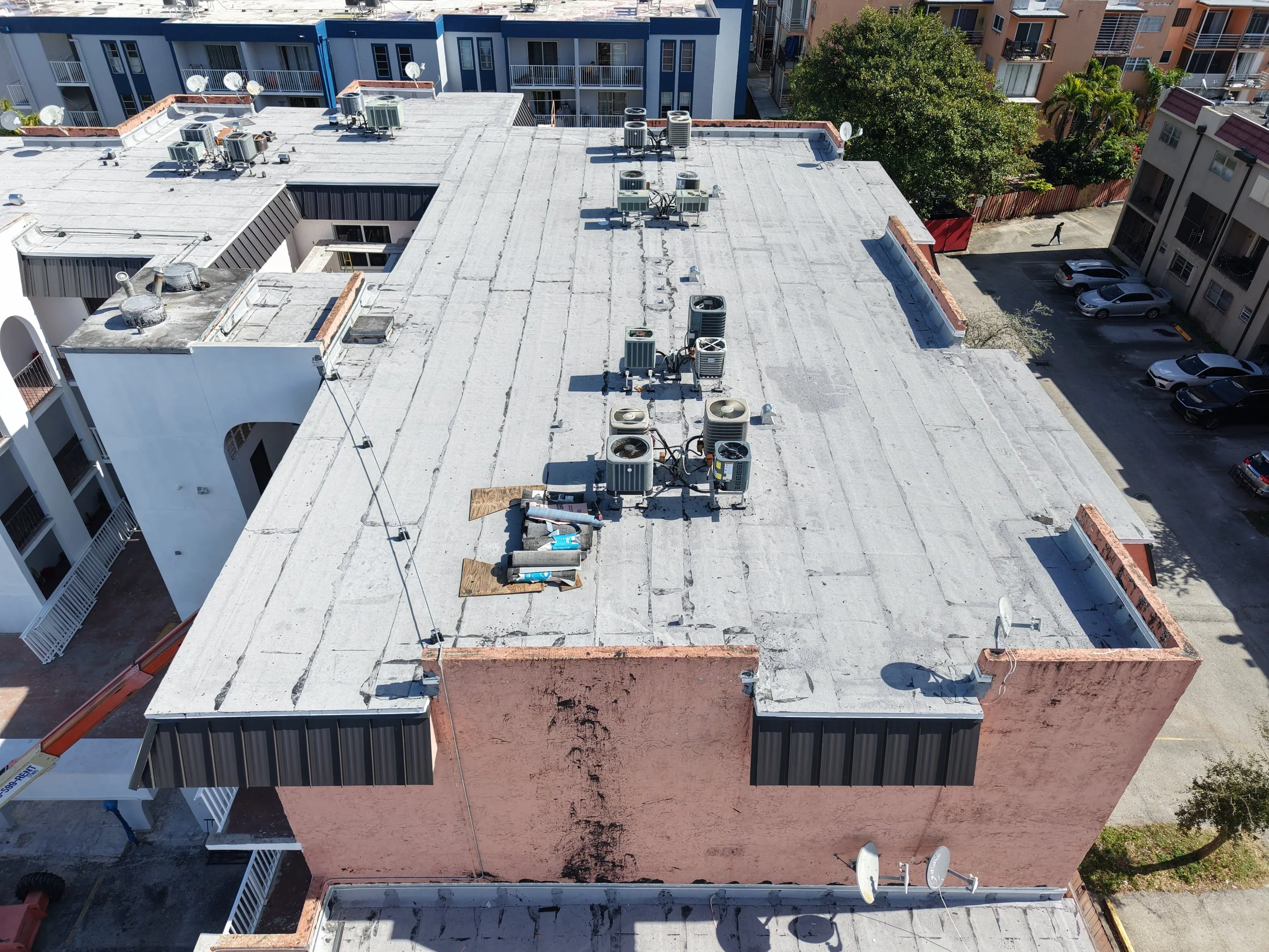 New flat roof system & new metal panel roofs throughout the whole building in Hialeah, Fl