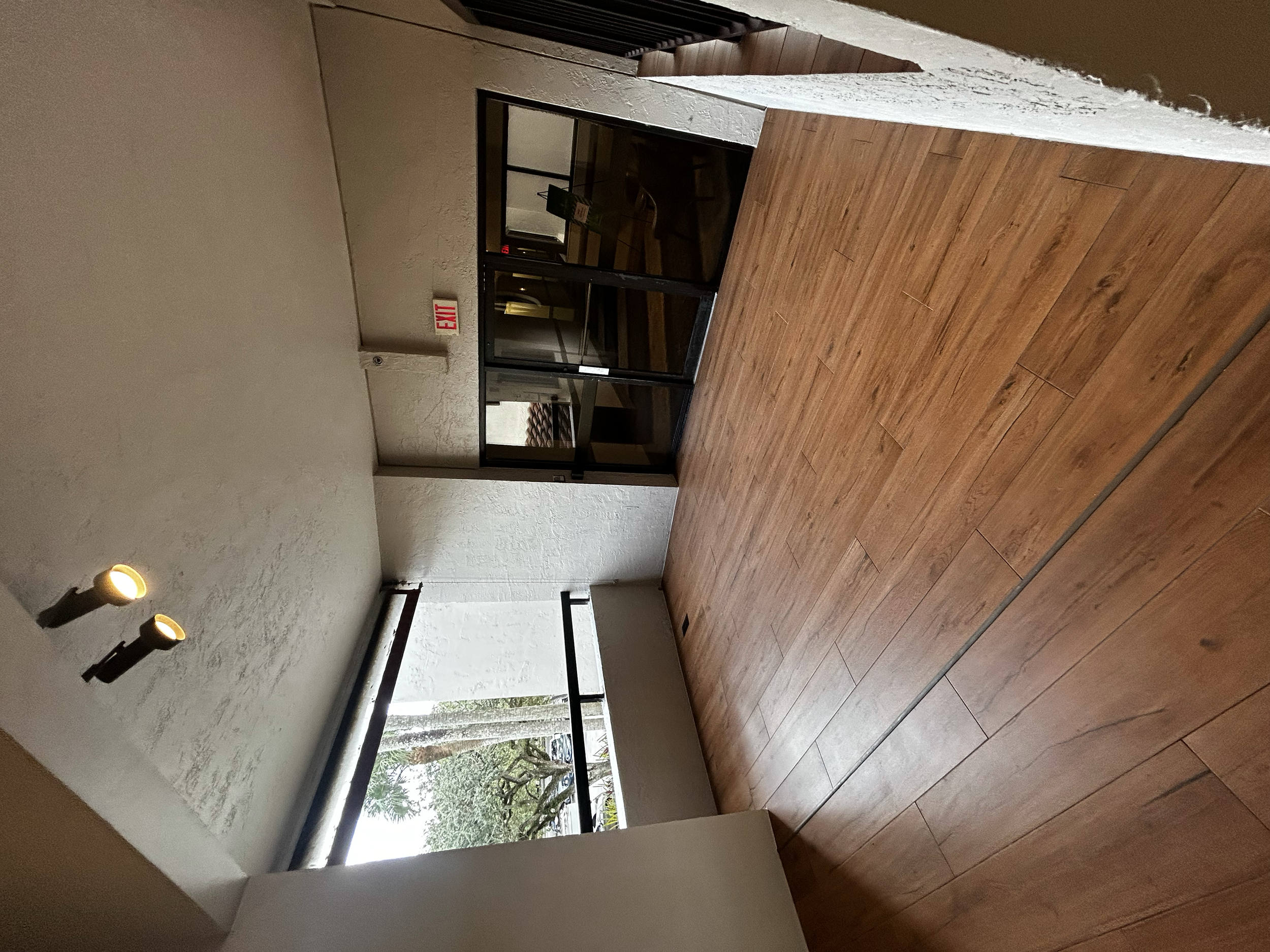 New porcelain tile installed + refurbished balcony rail + full paint job at Miami Lakes Hotel