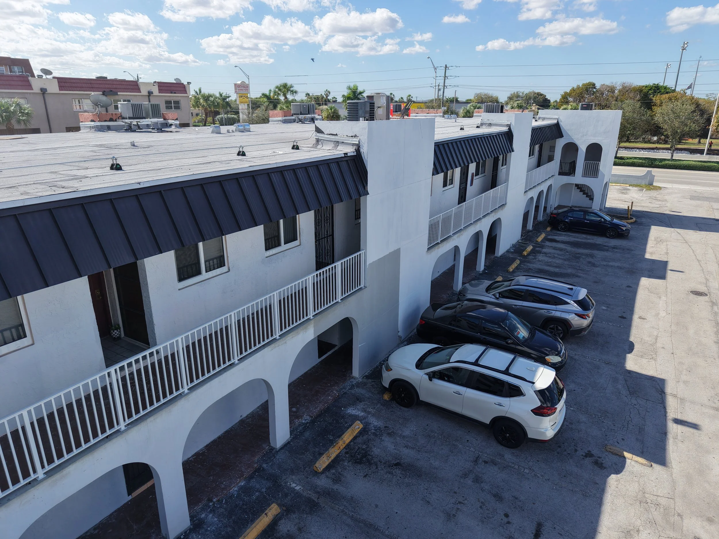 New flat roof system & new metal panel roofs throughout the whole building in Hialeah, Fl