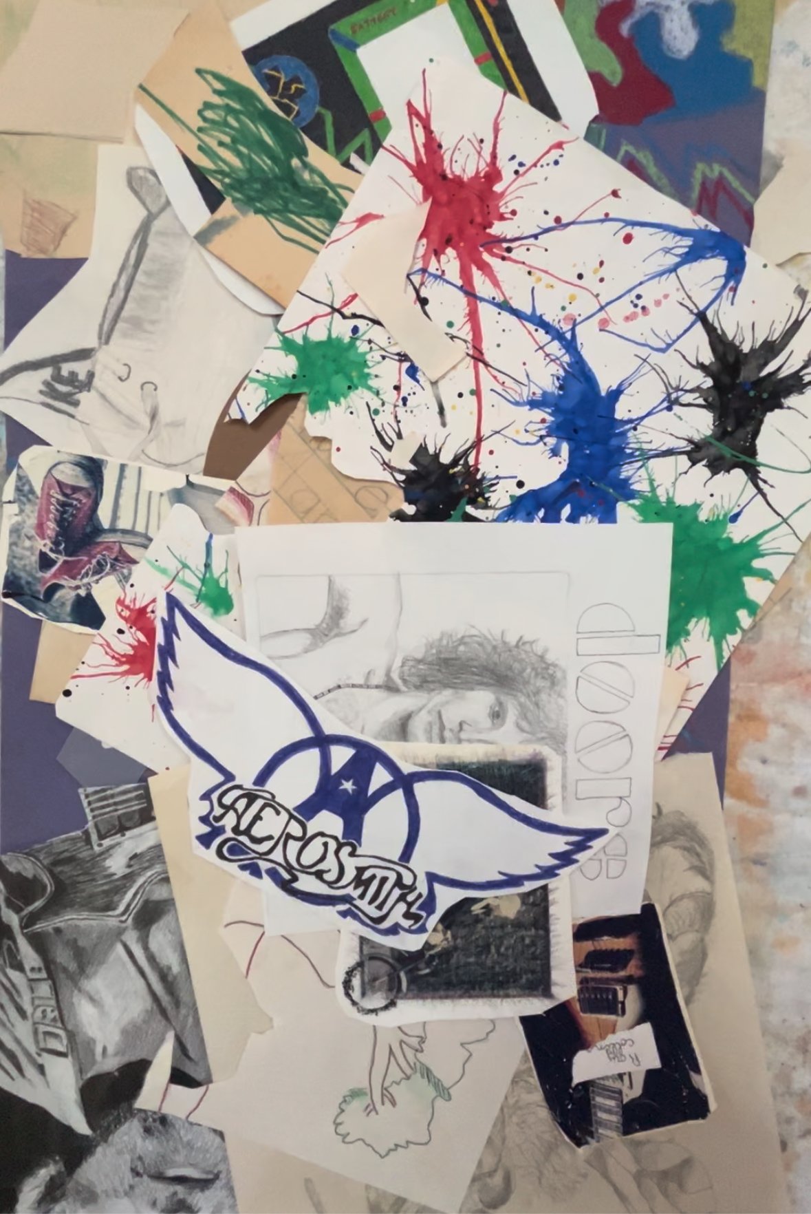 A collection of artwork scattered on a table.