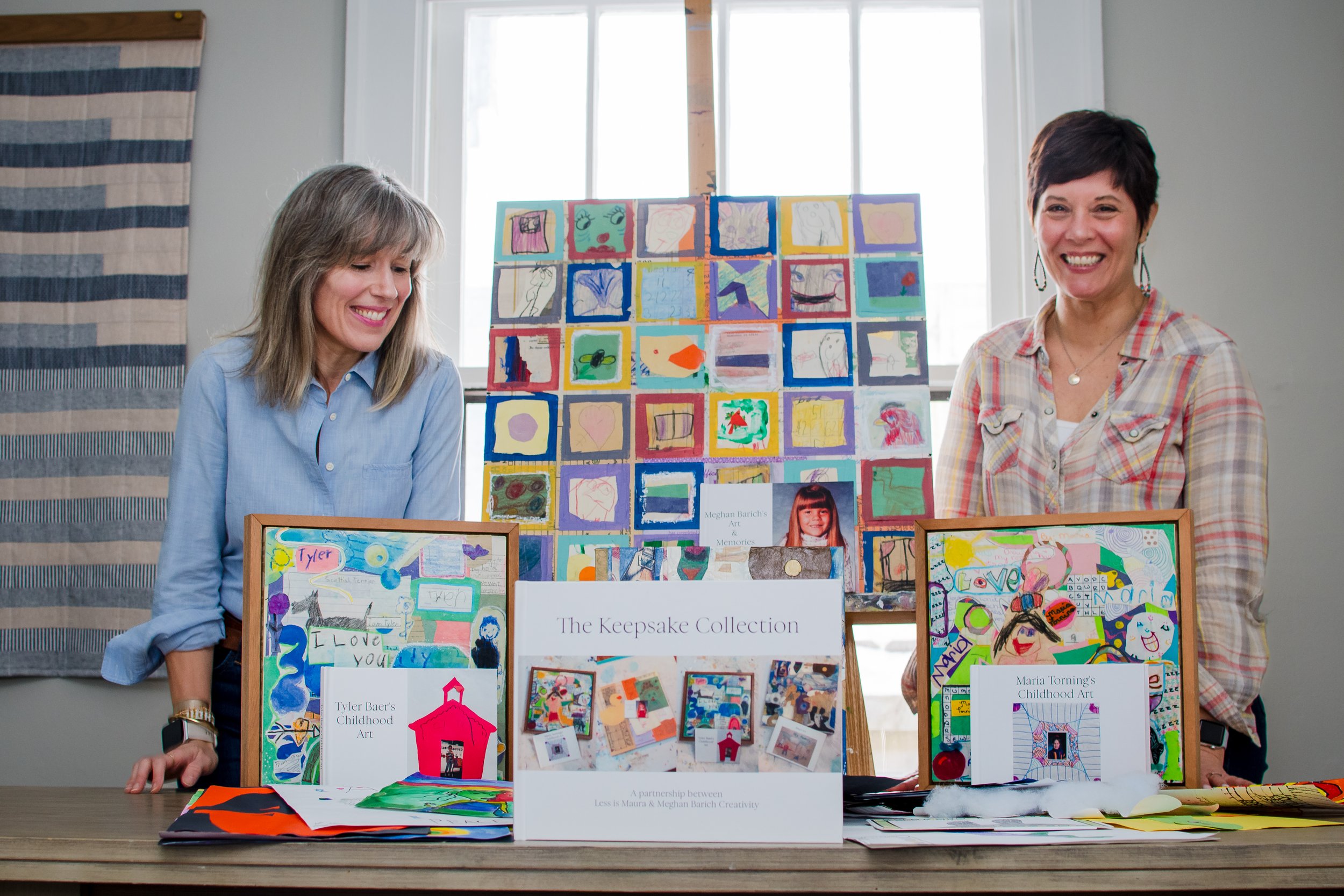 Maura and Meghan stand with a collection of Keepsake Collections on display.
