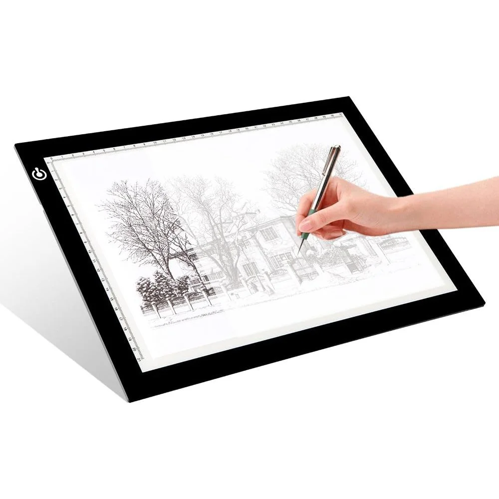 Hand tracing a drawing on a LitEnergy LED light box