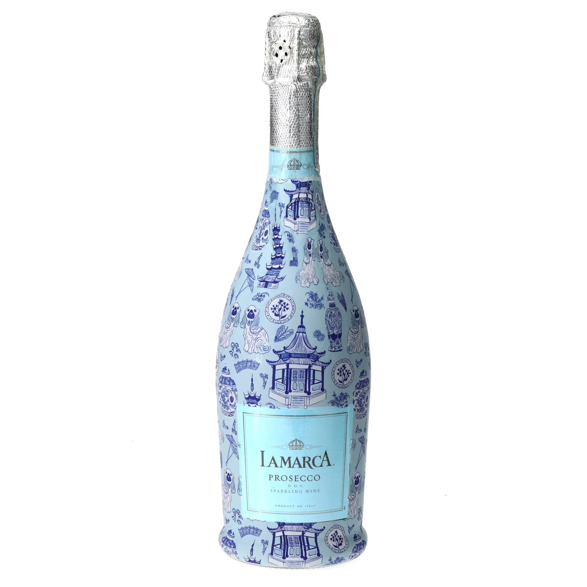 A bottle wrapped in Carrie Cantwell’s Cute Chinoiserie design, surrounded by mahjong tiles and champagne glasses on an elegant blue and white table setting.