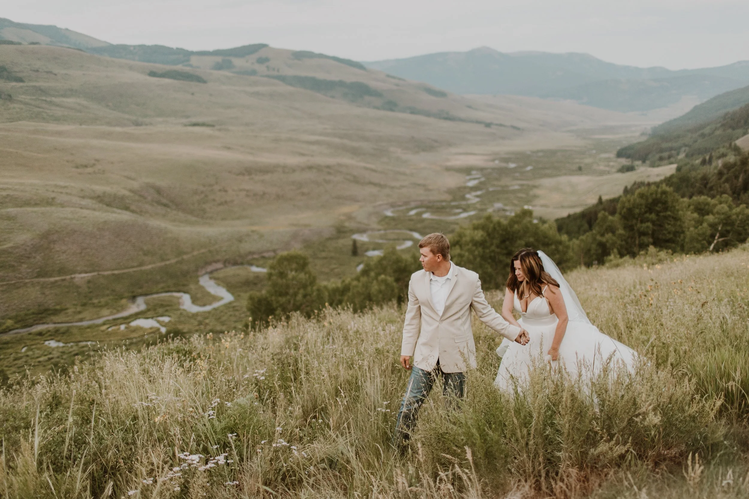 couple walking above river on Gothic Road