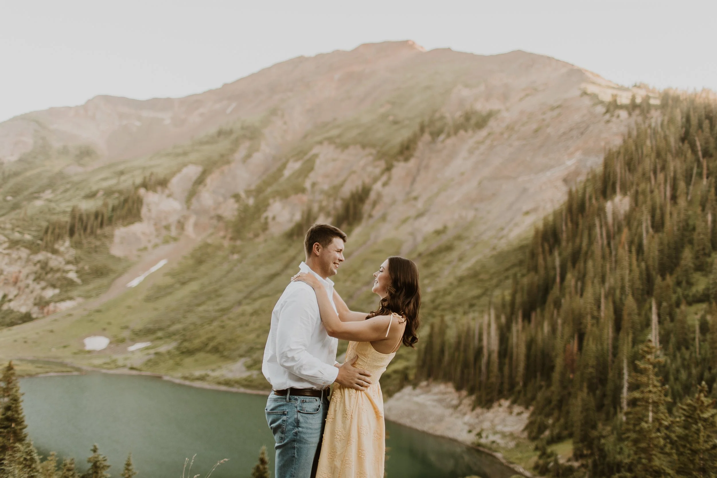 couple embracing above lake in Crested Butte