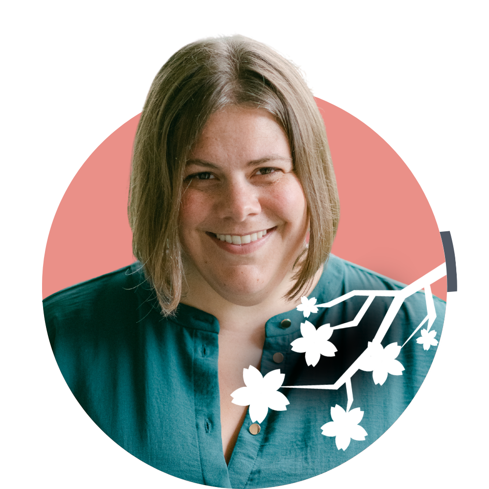 Thumbnail image of associate therapist Kate McDermott: A woman with shoulder-length brown hair smiling, wearing a teal top, with a pink background and a white floral branch graphic overlay.