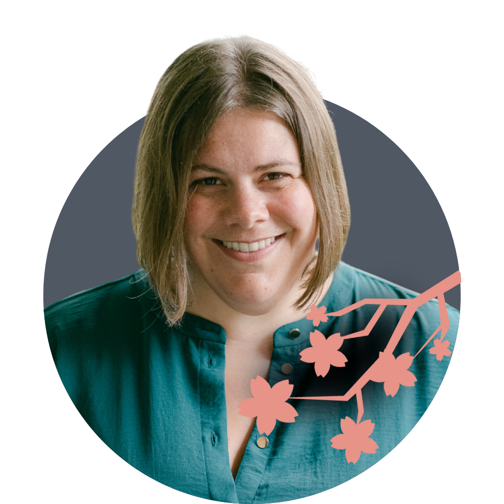 Thumbnail image of associate therapist Kate McDermott: A smiling woman with shoulder-length brown hair wearing a teal shirt, with a pink cherry blossom branch graphic over her shoulder.