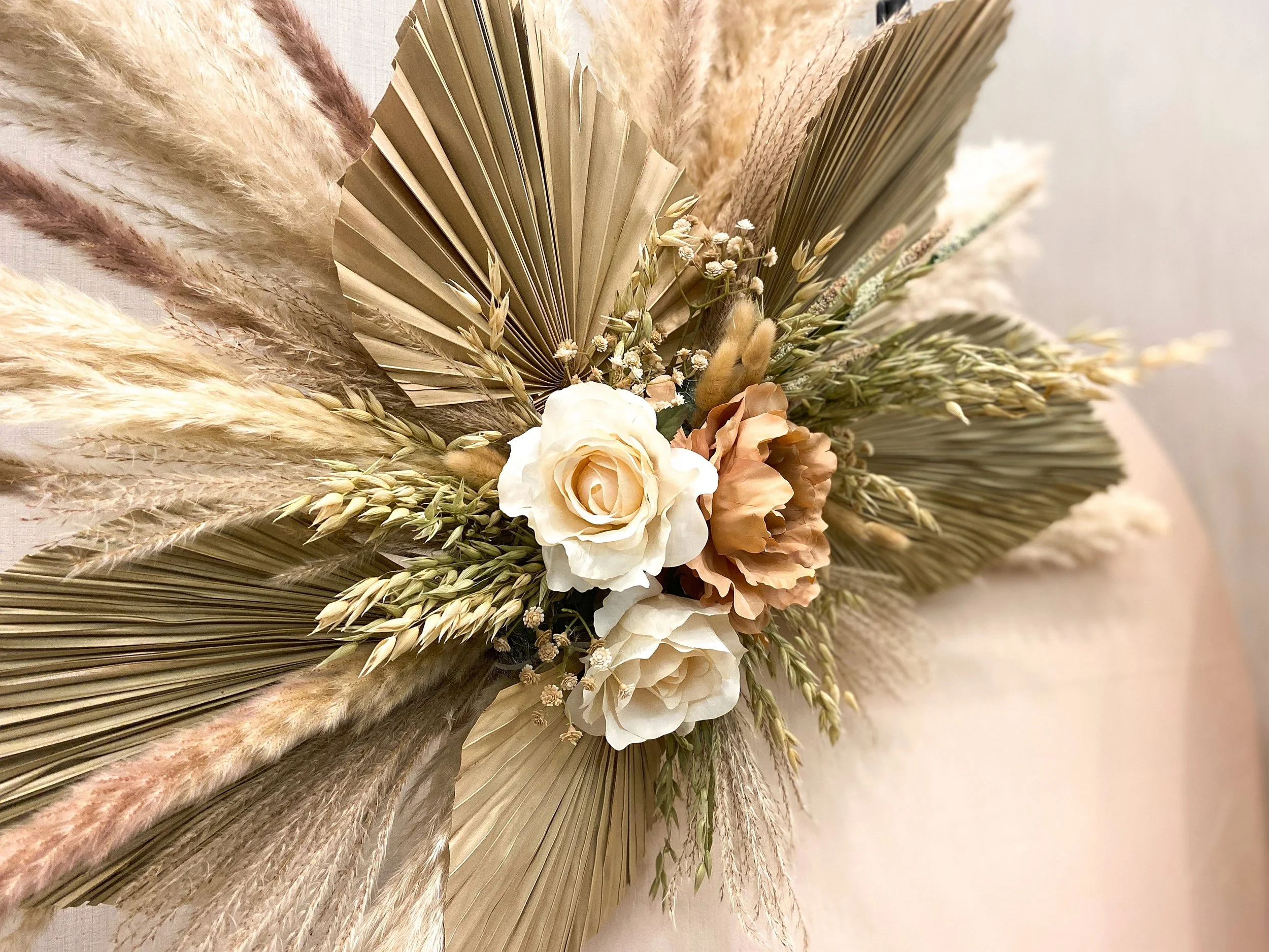 Authentic pampas grass floral arrangements with faux roses in the center.
