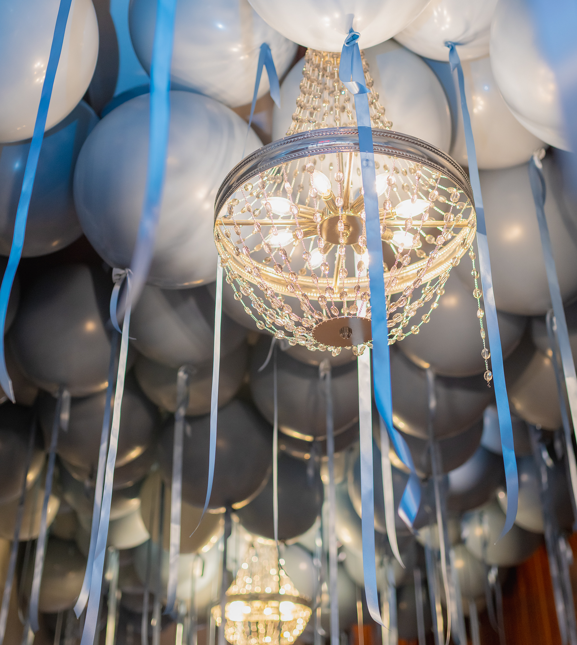 Helium ceiling balloon surrounding chandelier at the London Tea Room St. Louis